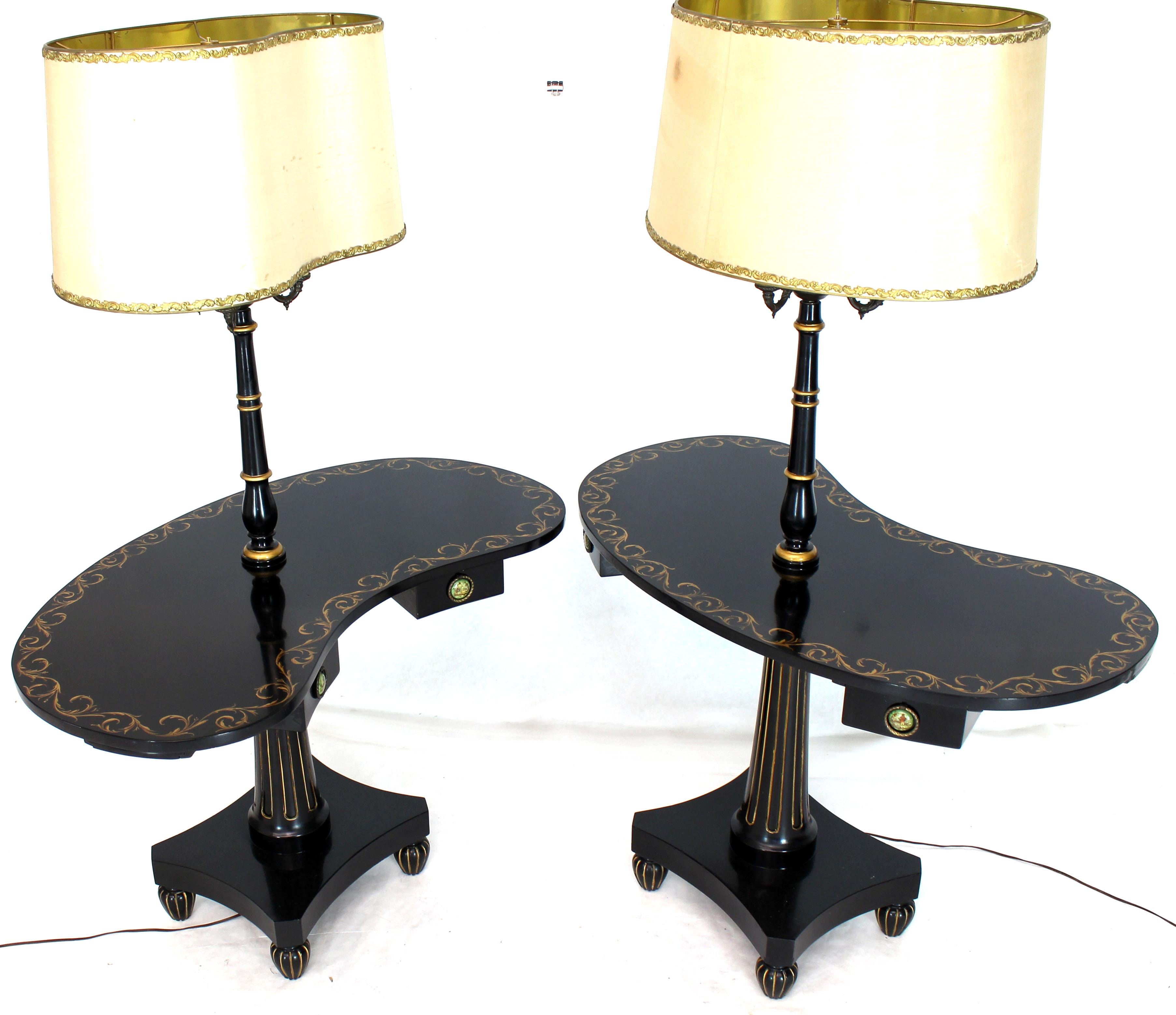 Turned and tapered bases black lacquer and gold decorated Art Deco style, circa 1940s kidney shape occasional tables floor lamps. Adams style gold decoration.