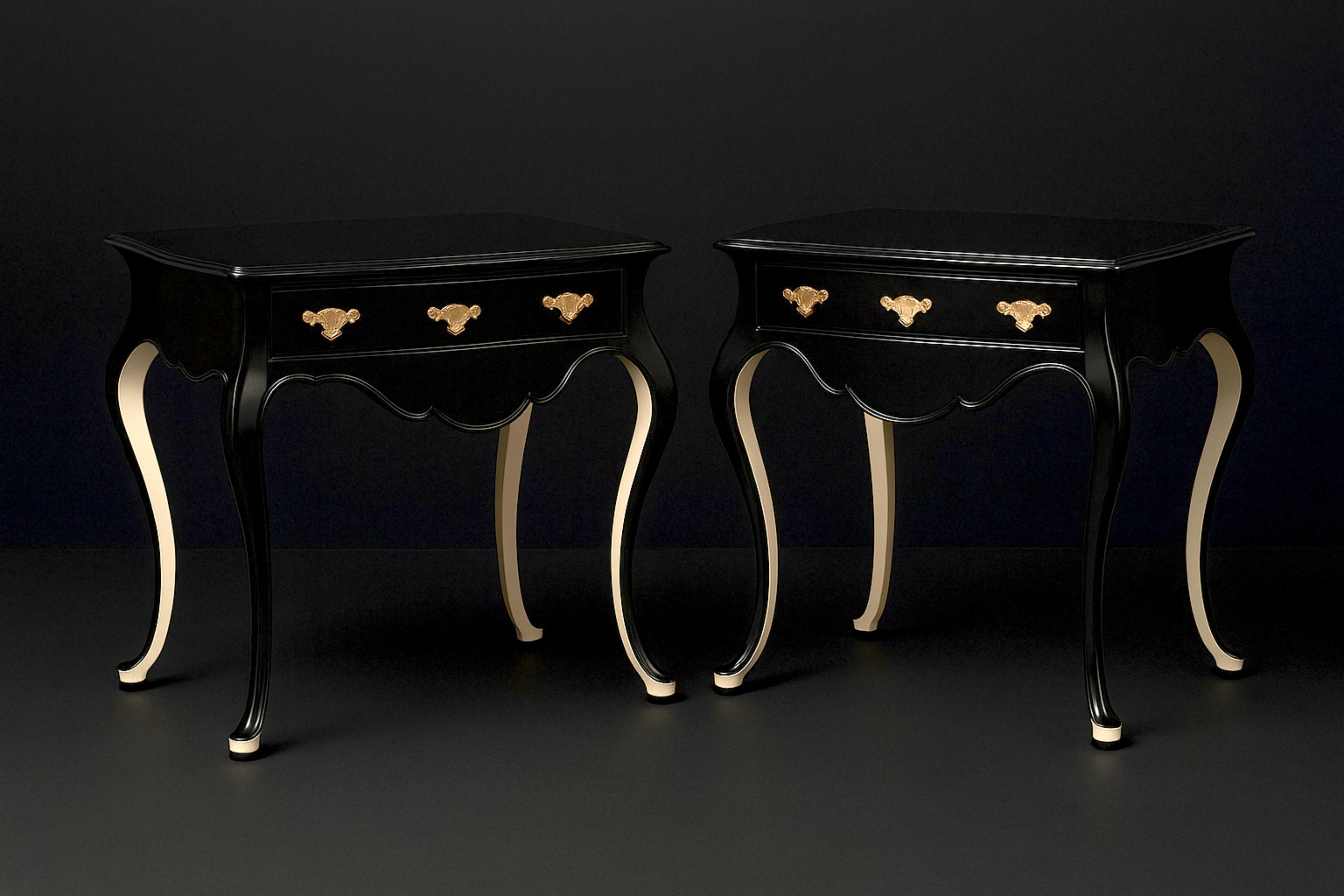 Elevate your space with this high-end Portuguese Baroque-style wood table commode refinished with off white shoes and back legs, now re-imagined in sleek black lacquer by expert artisans. Featuring a single drawer with a cut-out top that follows the