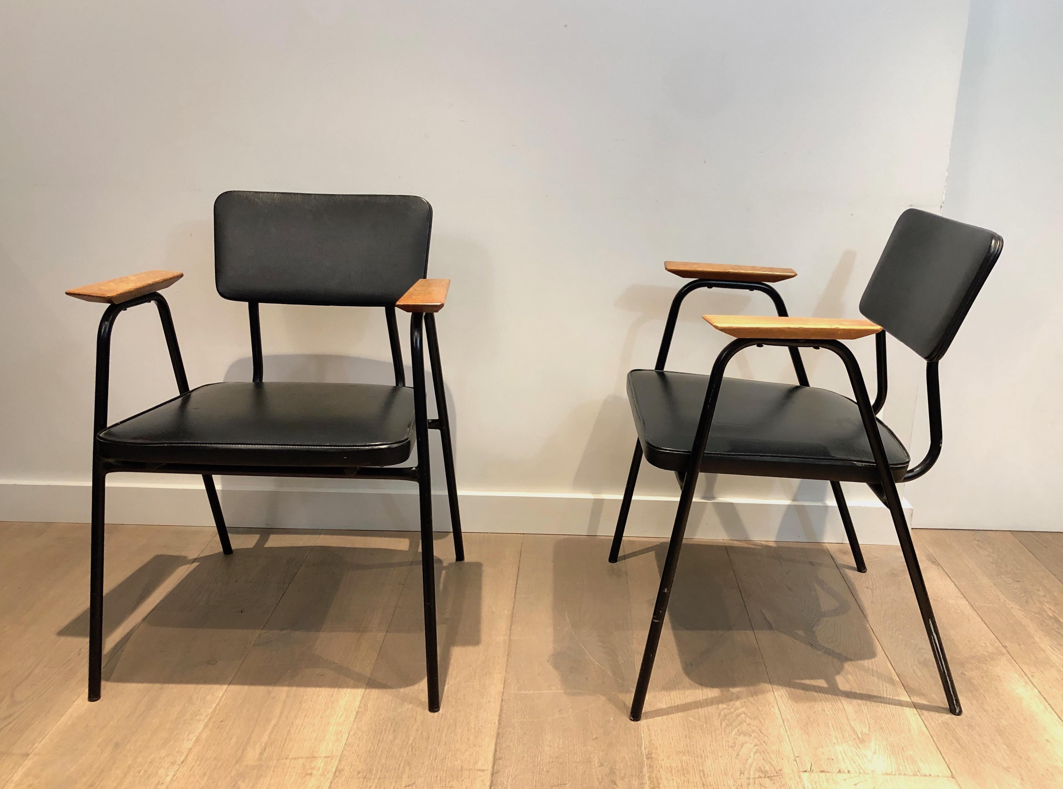 Dieses Sesselpaar ist aus schwarz lackiertem Metall und schwarzem Kunstleder mit Holzarmlehnen gefertigt. Dieses Werk wird dem berühmten belgischen Designer Willy Van der Meeren zugeschrieben, um 1950.