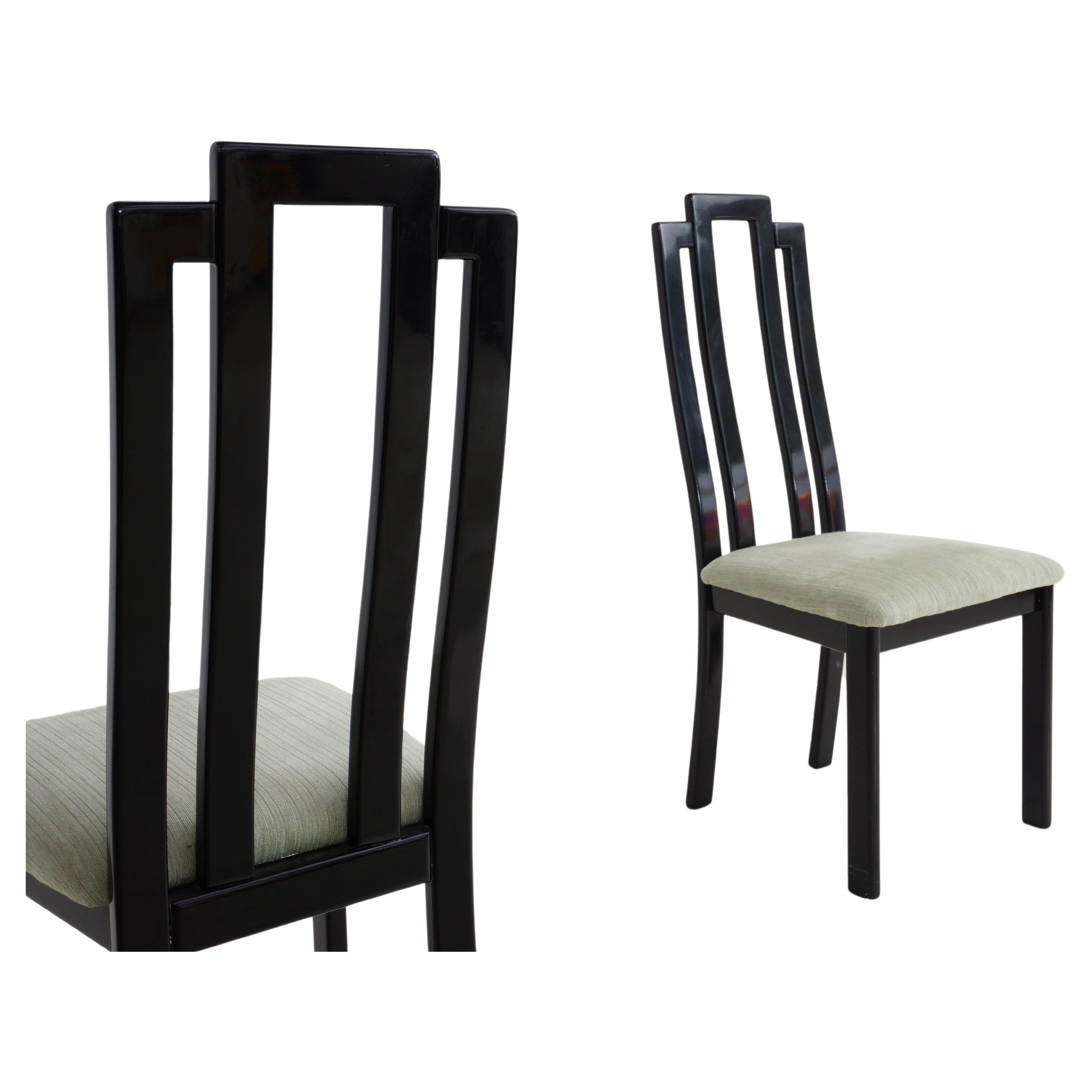 These postmodern dining chairs are the epitome of sleek sophistication, dressed in a sumptuous coat of black lacquer that exudes timeless elegance. With sinuous lines and a dash of audacious flair, they effortlessly blend the avant-garde with the