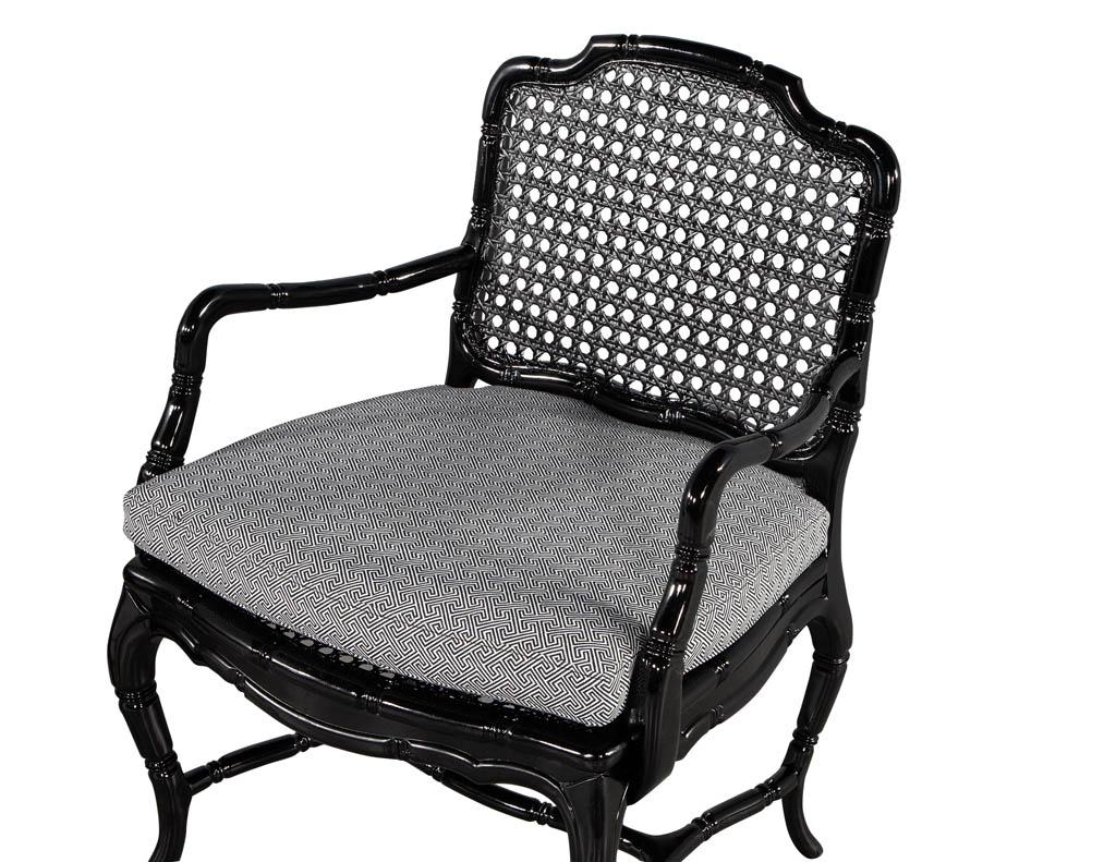 American Pair of Black Lacquered Cane Back Lounge Chairs For Sale