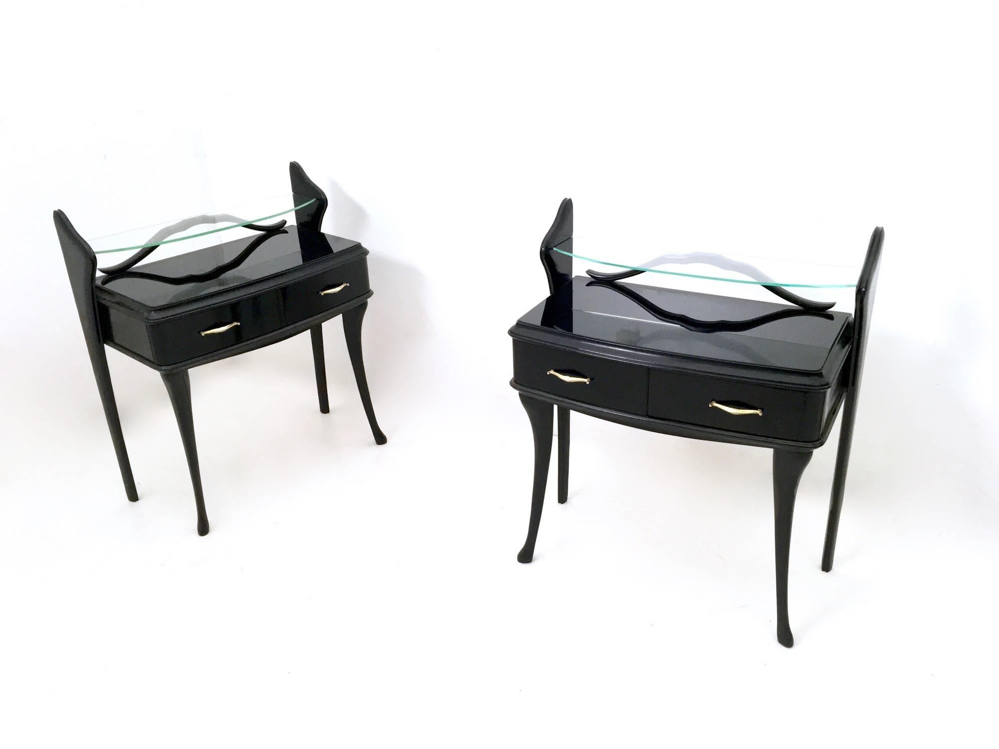 Made in Italy, 1950s.
These stunning nightstands feature a black lacquered beech frame, a glass shelf and a back-painted glass top.
They are vintage, therefore they might show slight traces of use, but since they have been recently restored they
