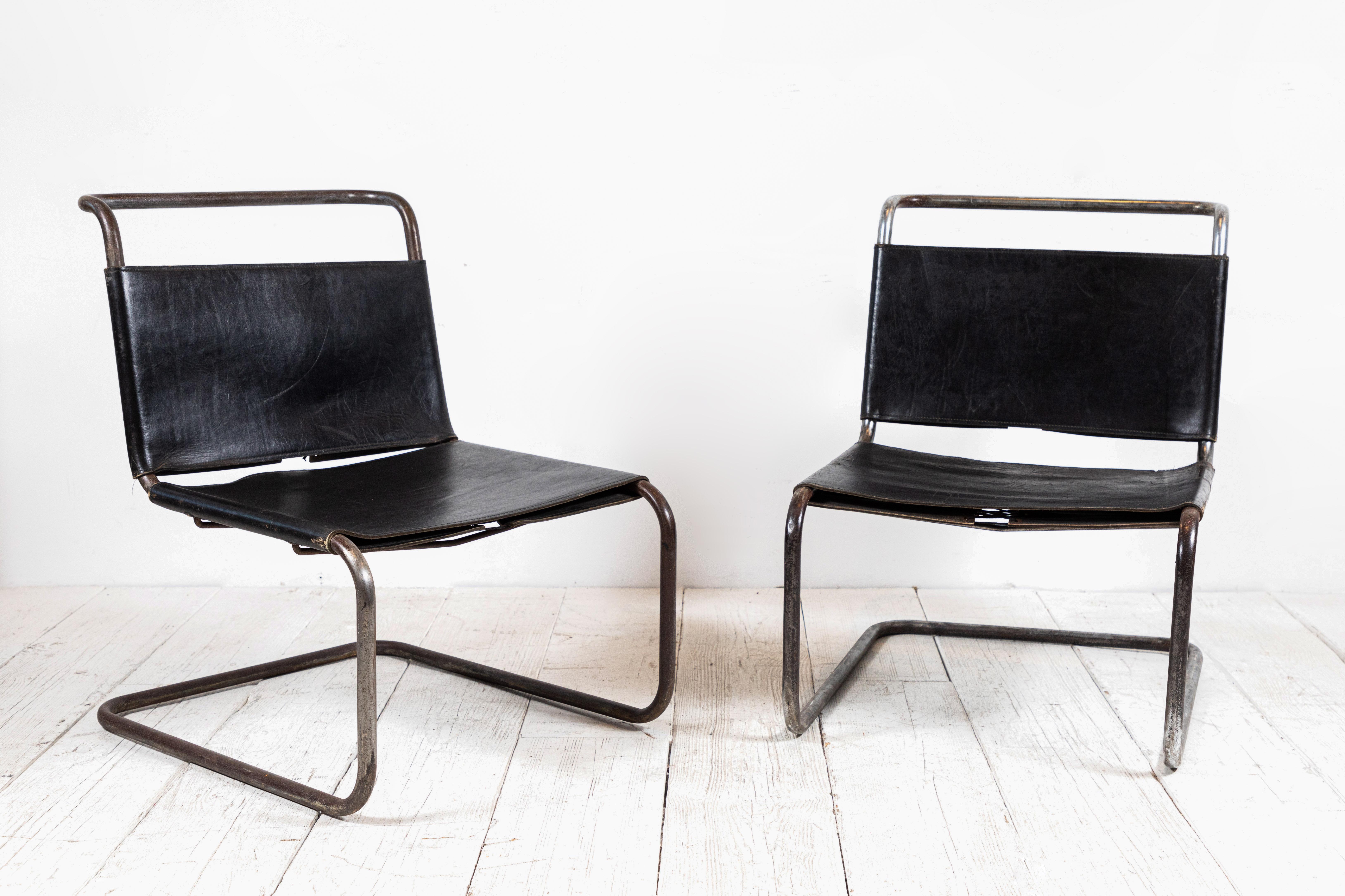 French pair of black leather chairs with chrome frame. The leather and chrome are both aged to a beautiful patina. The leather seat and back are held together with lashings.