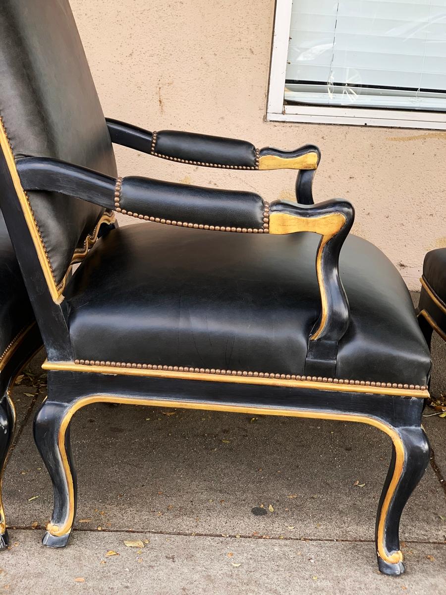 Pair of Black Leather Armchairs and Ottomans, circa 1960s In Good Condition In Los Angeles, CA