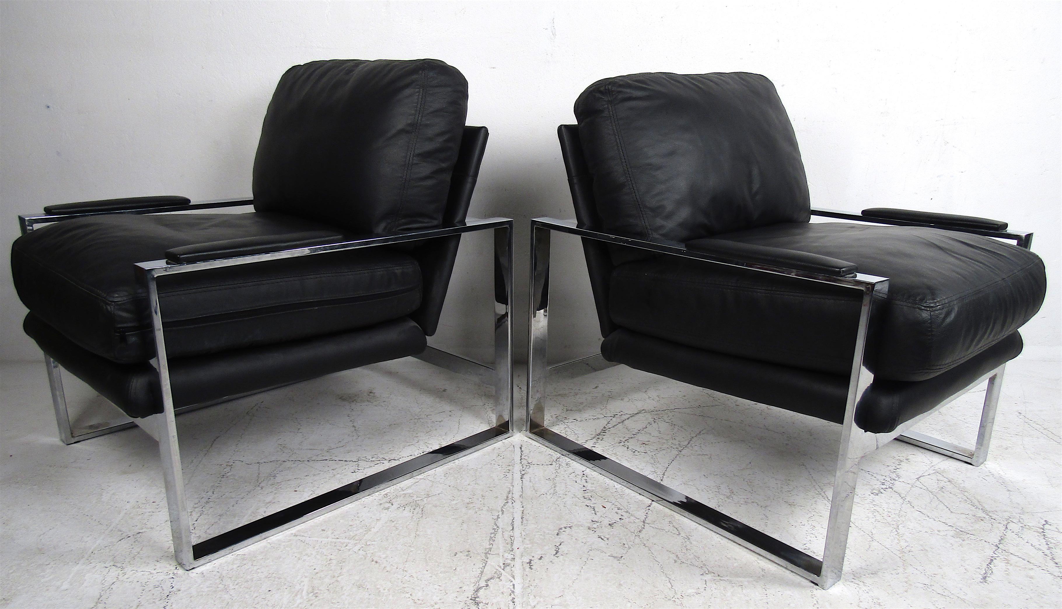 This stunning pair of modern lounge chairs boast overstuffed removable cushions and a heavy flat bar chrome frame. The padded armrests and smooth black leather upholstery make this pair the perfect addition to any seating arrangement. These make the