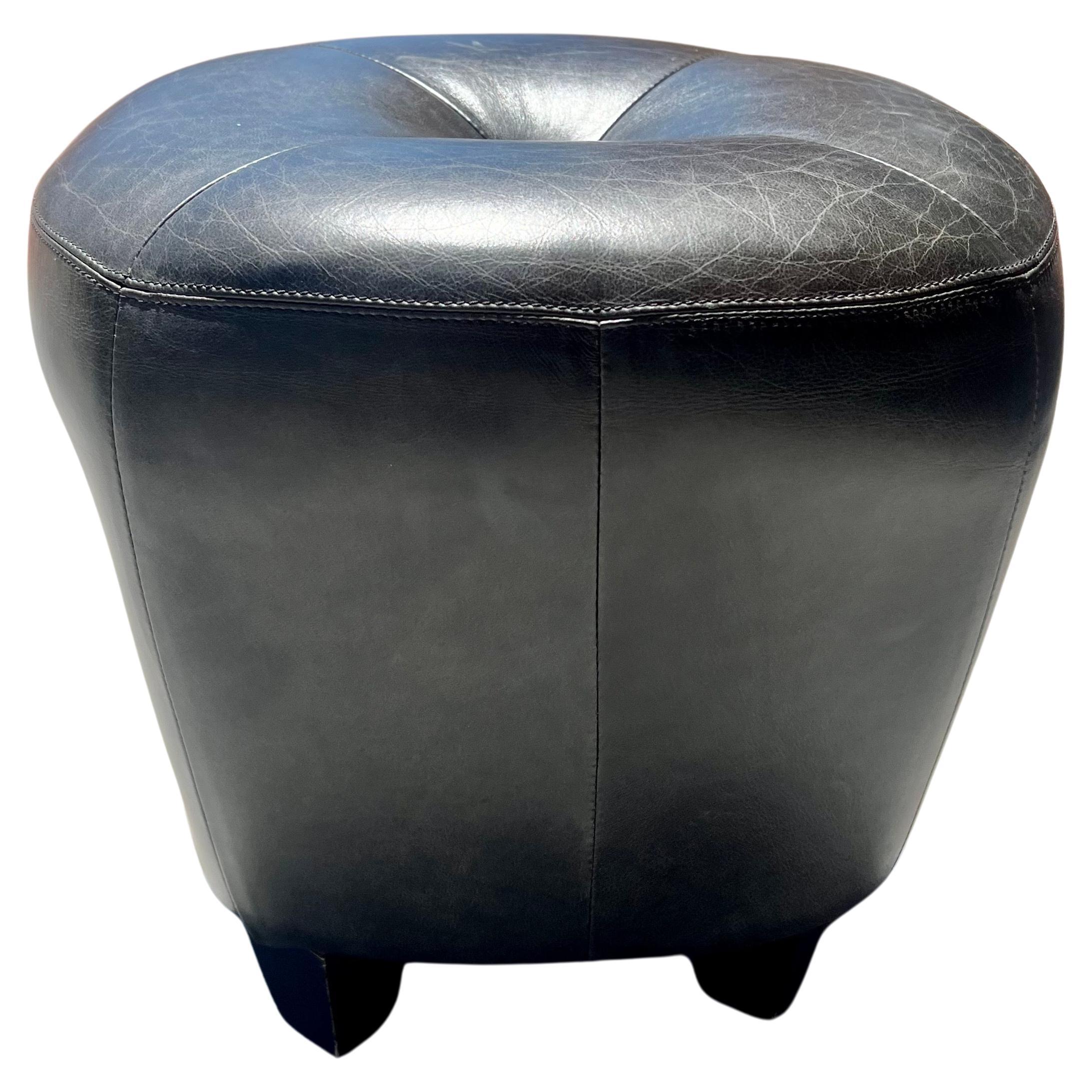 Elegant pair of black leather stools , ottomans or poufs , great condition leather with hand stiched finish and black lacquer wood legs, by Cisco & Bros .