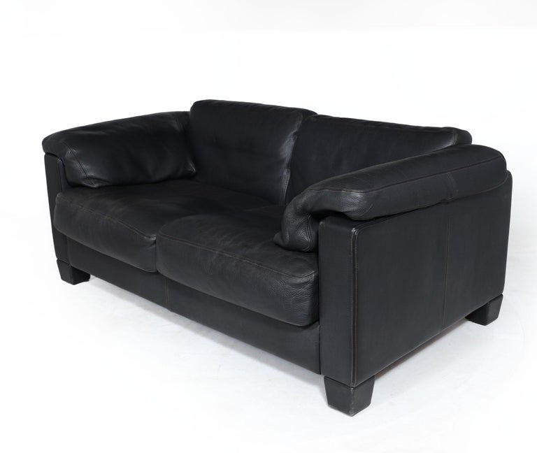 Designed in 1989 by Desede this pair of DS17 sofas are in very good condition produced in exceptionally thick black aniline leather on a part steel and hardwood frame the sofas are very heavy and would last for many years. Quality manufacturing as