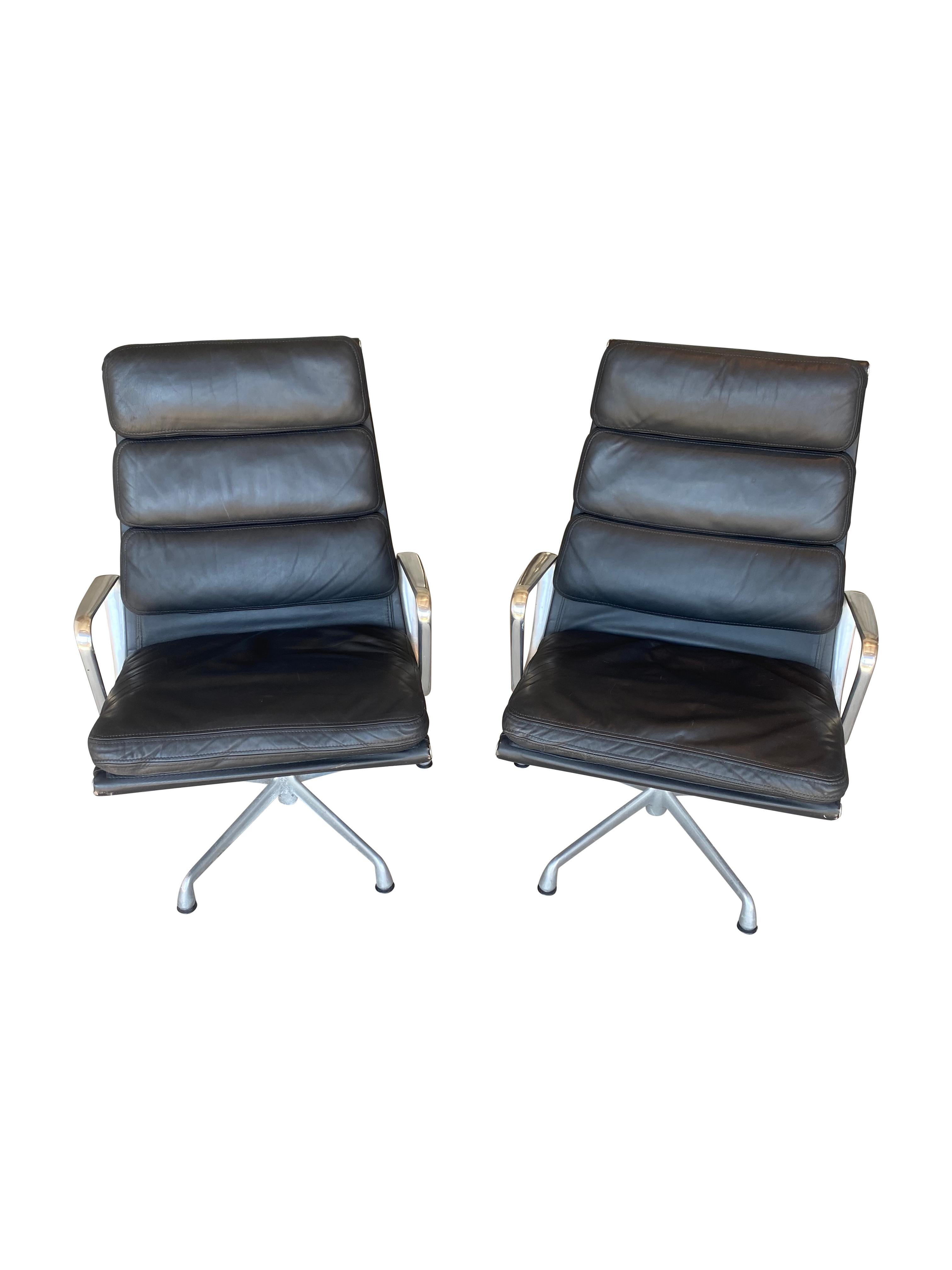 Pair of Eames soft pad aluminum group lounge chairs. Executed in polished aluminum and soft black leather. In excellent original condition. All parts present. Stamped Herman Miller into frame. Even color and condition. Bases retain all nylon foot