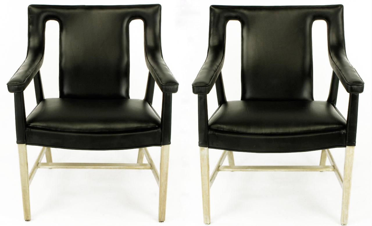 Pair of restored Ejner Larsen and Aksel Bender Madsen black leather armchairs. Model LP48. Single piece bentwood back and arms. Elliptical seat with bleached and glazed mahogany legs and stretchers. The new Spinneybeck black leather wraps all