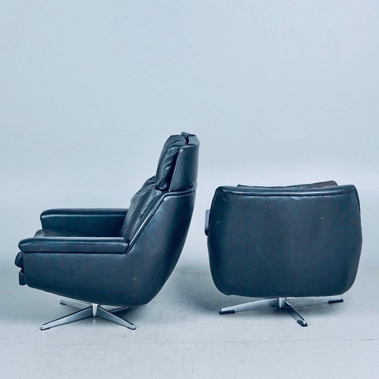 Pair of midcentury Danish lounge chairs and a ottoman.  The armchairs designed by Werner Langefeld for ESA Møbelværk in Denmark dates from the 1960s. One of the chairs are the rarer version without the headrest. The club chairs are in original