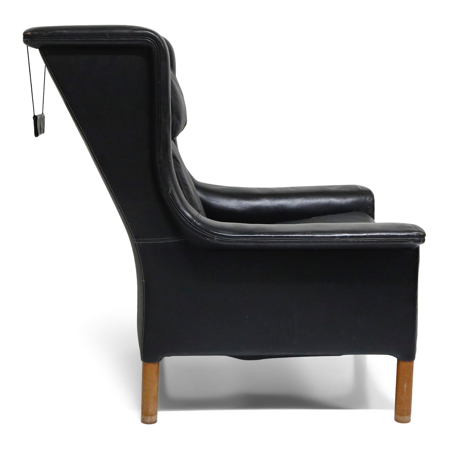 Pair of Black Leather Wingback Chairs and Ottoman by Gerhard Berg, 1965 In Good Condition In Los Angeles, CA