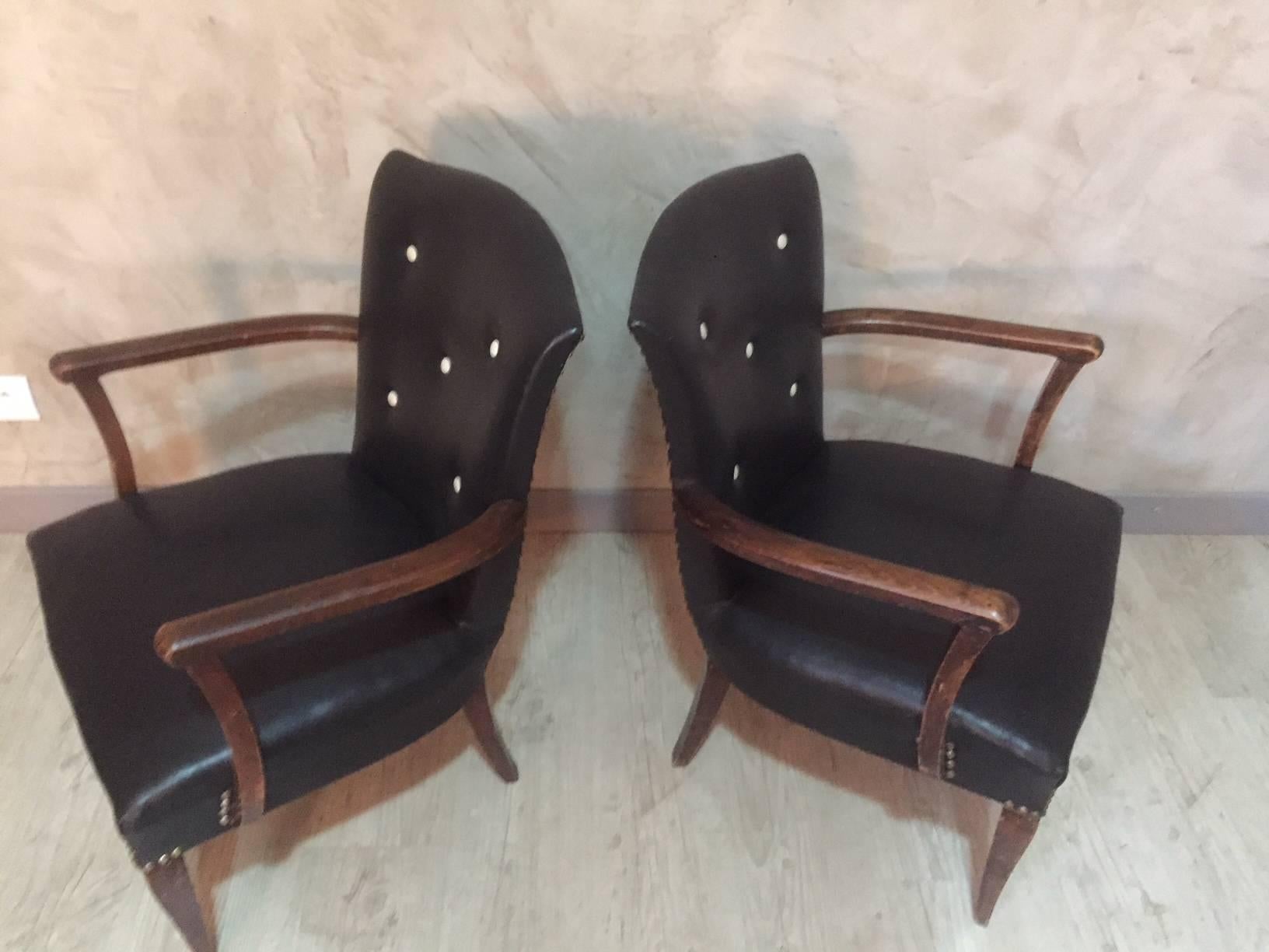 Nice pair of black leatherette lounge chairs from the 1940s. 
Finishing nails.