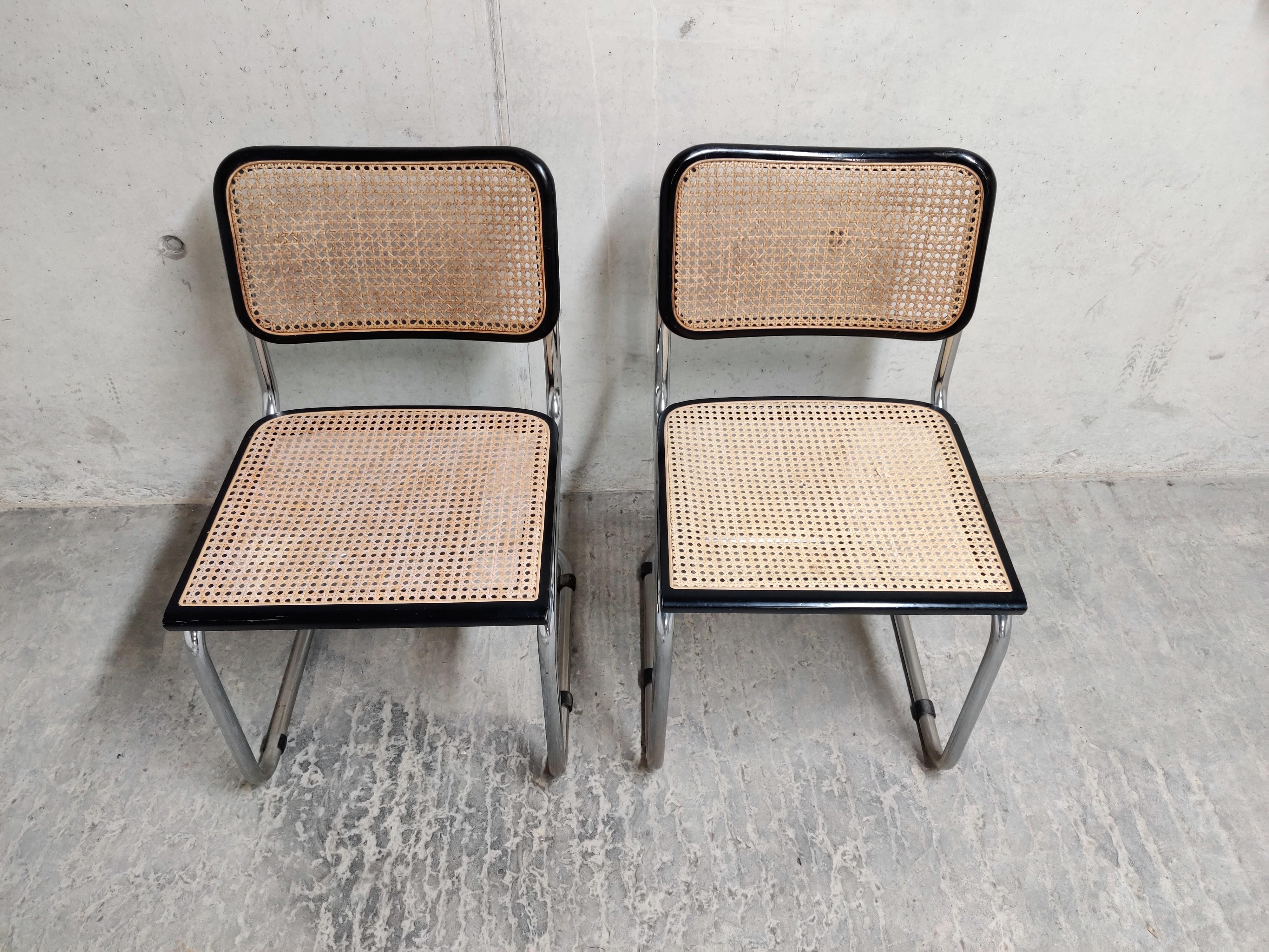 Pair of Marcel Breuer Bauhaus design chairs model B32. Original design dates from 1926.

Tubular chrome frame, cane seats and black lacquered wood.

Very good condition.

Stamped 'made in Italy' and manufactured in the