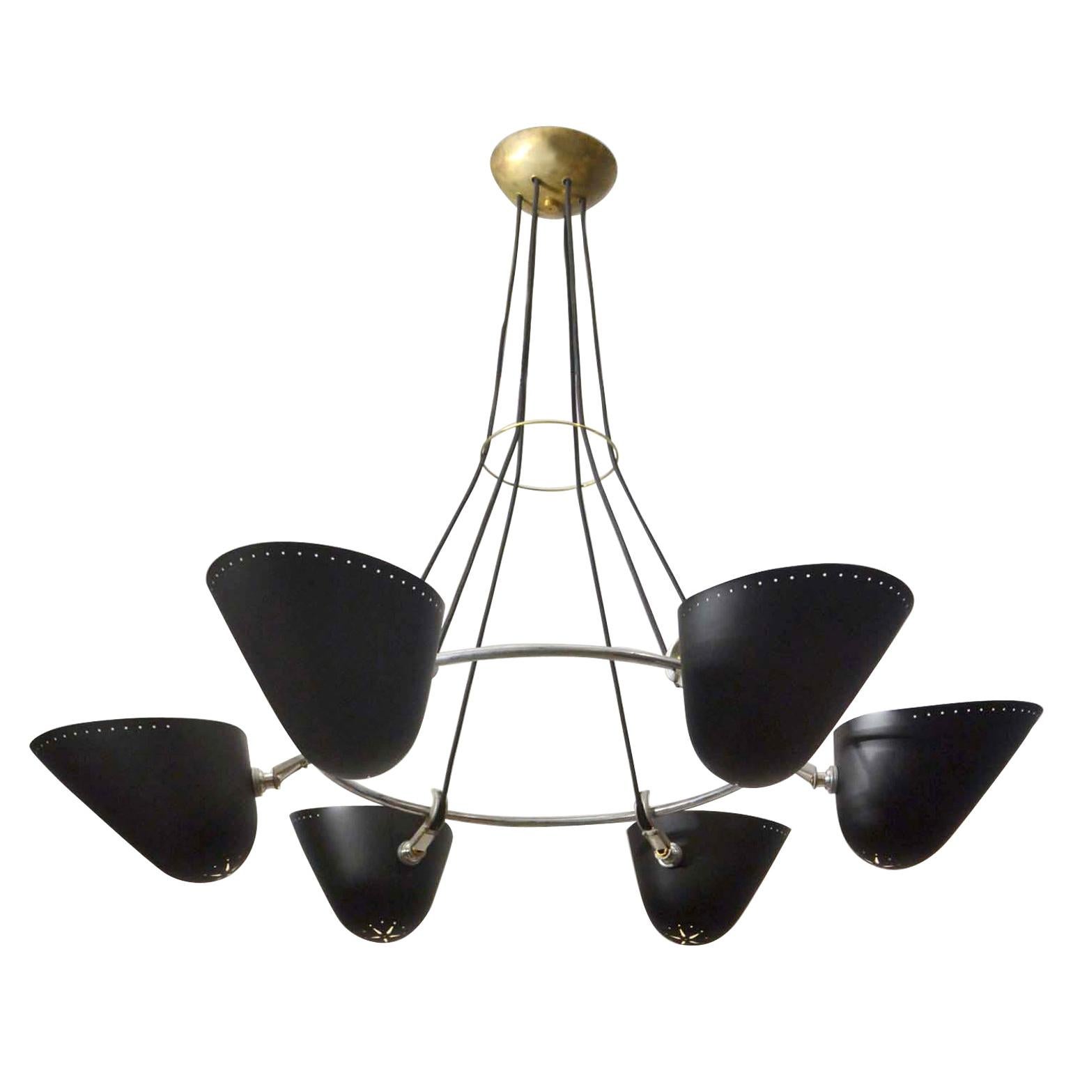Pair of original Mid-Century Modern chandeliers, six black metal perforated shades. They are attached to a nickel-plated ring connected with joints. A brass ring holds the cords together and leads to a brass ceiling rose which gives the chandeliers