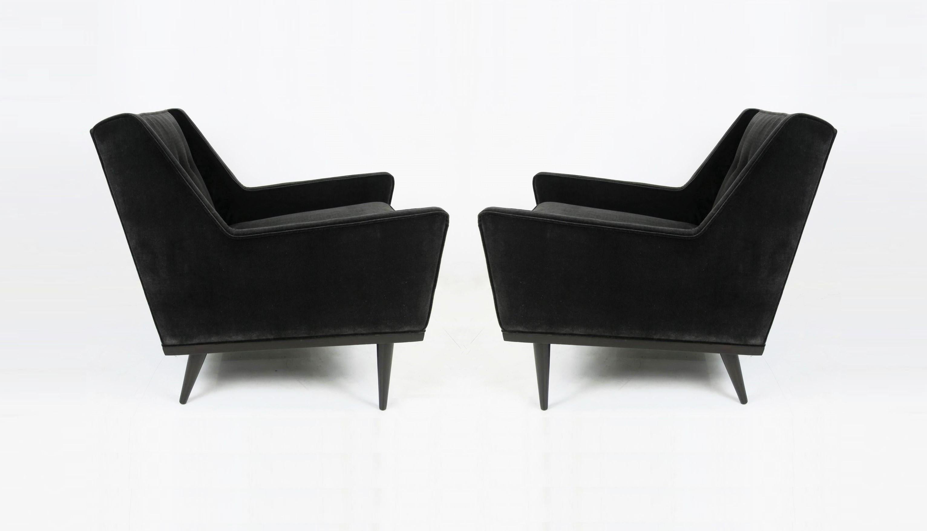 Absolutely stunning club lounge chairs designed by Milo Baughman for James Inc, an early imprint of Thayer Coggin. Defined by their Classic midcentury lines and simple walnut framed base. This pair features sculptural low slung form, pointed corners