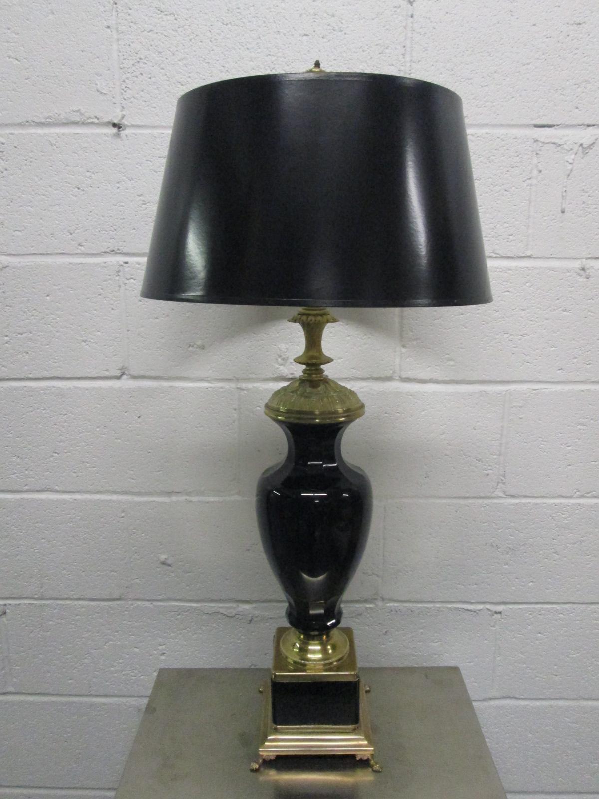 Pair of black opaline and brass lamps. Has claw feet to the base. 
Measures: 35.25