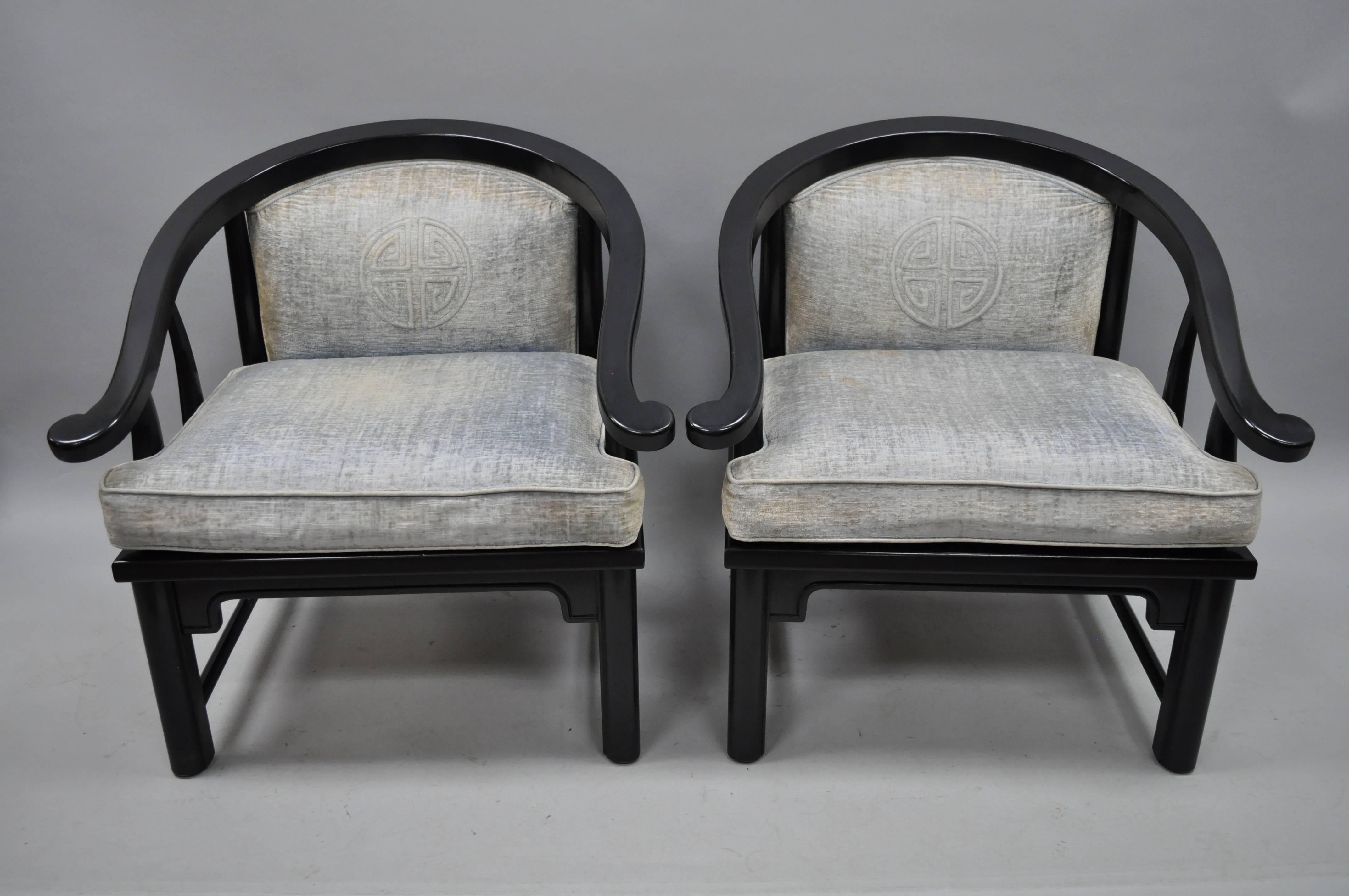 Pair of vintage black oriental Asian style horseshoe lounge chairs by Century Chair Company of Hickory, N.C. in the James Mont Style. Chairs feature heavy solid wood frames, horseshoe form curved backs, upholstered backs and seats, and original