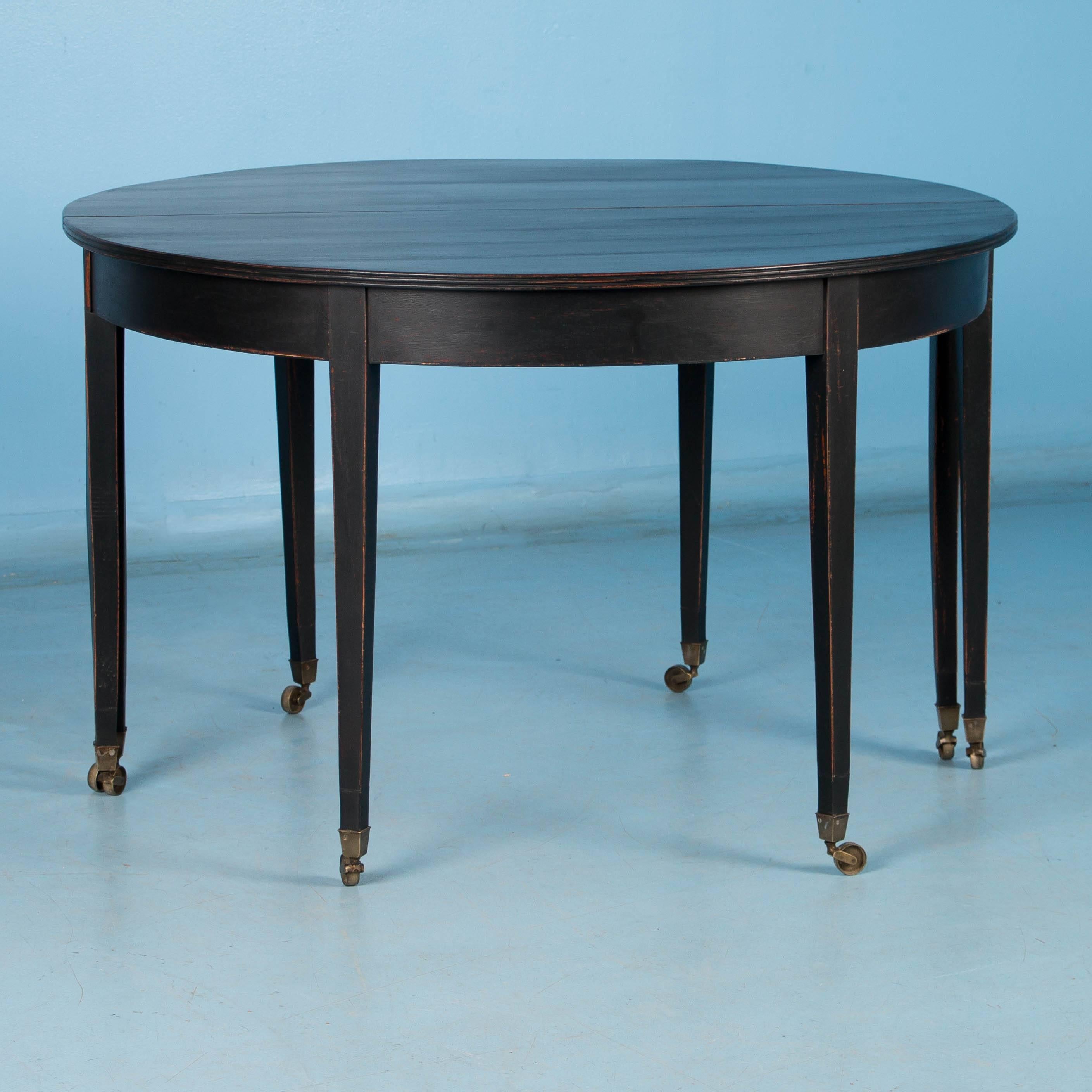 These striking Swedish demilune tables are so versatile. Used separately they make elegant consoles while pushed together they make an almost 4 ft. diameter round table. There is also a 23