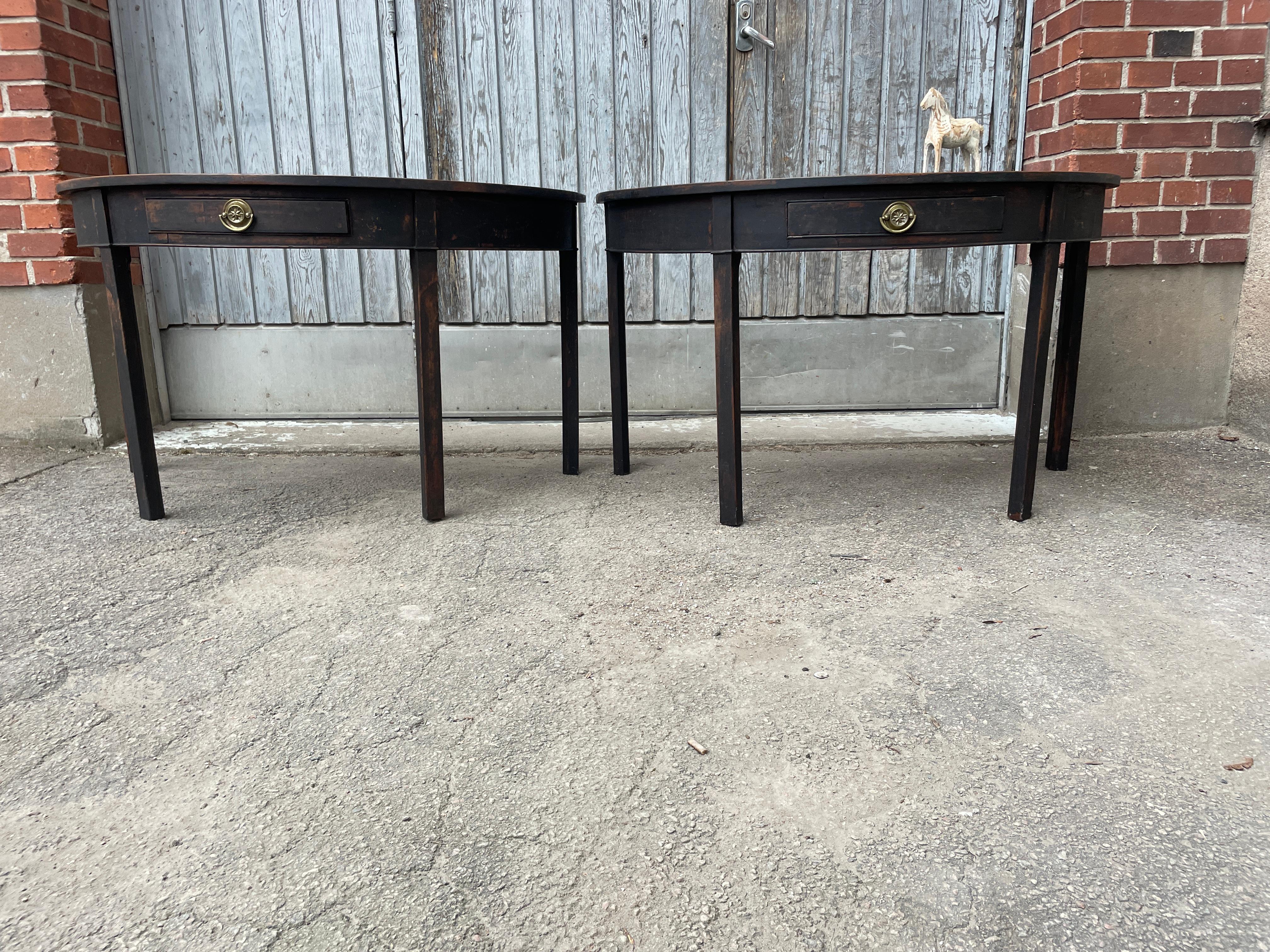 Black Painted Gustavian Demilune Table Consoles, A Pair

Impressive Pair of Black Swedish Half-Round Demi-Lune Tables with Brass Hardware. Put together this set makes a fantastic round table. Very functional pieces either used individually or