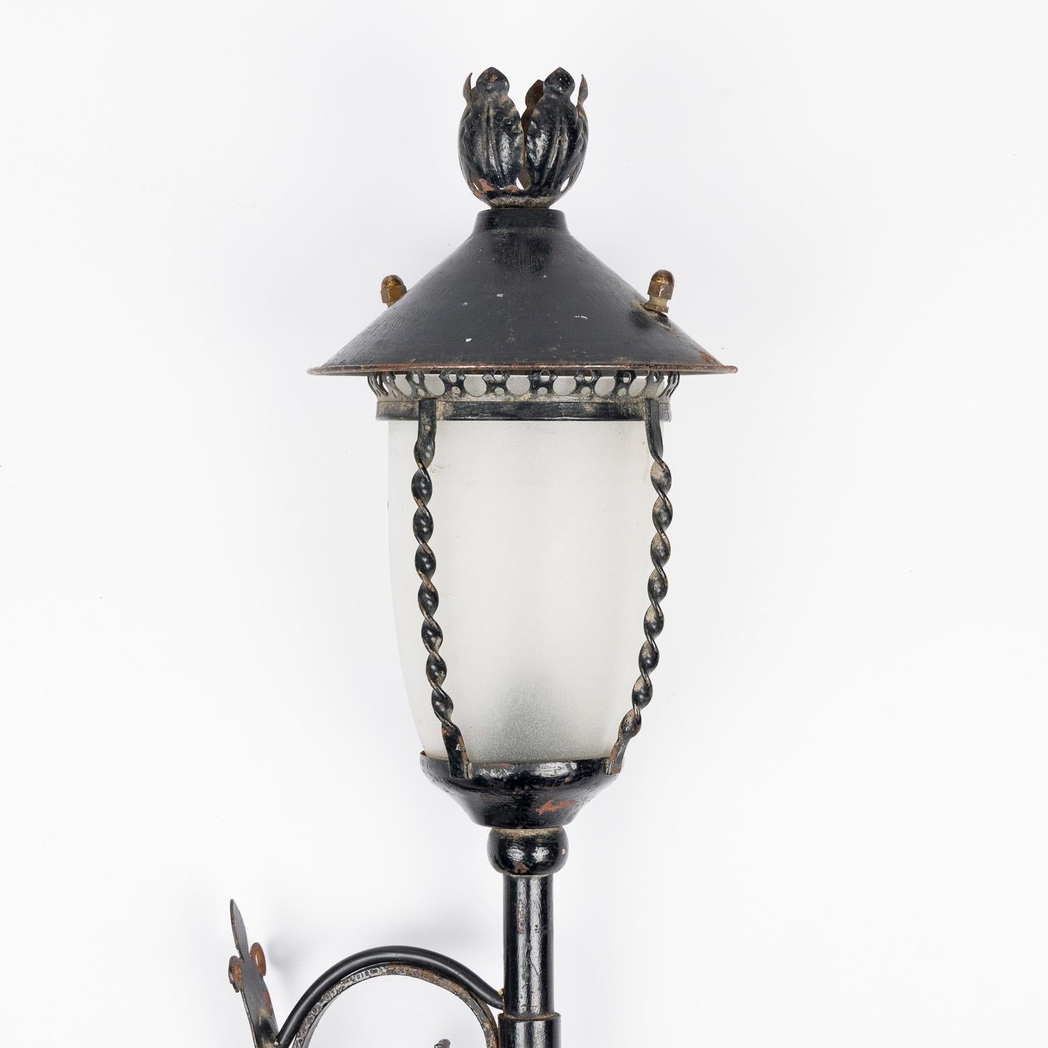 Frosted Pair of black painted wrought iron wall lights, with frosted shades. For Sale