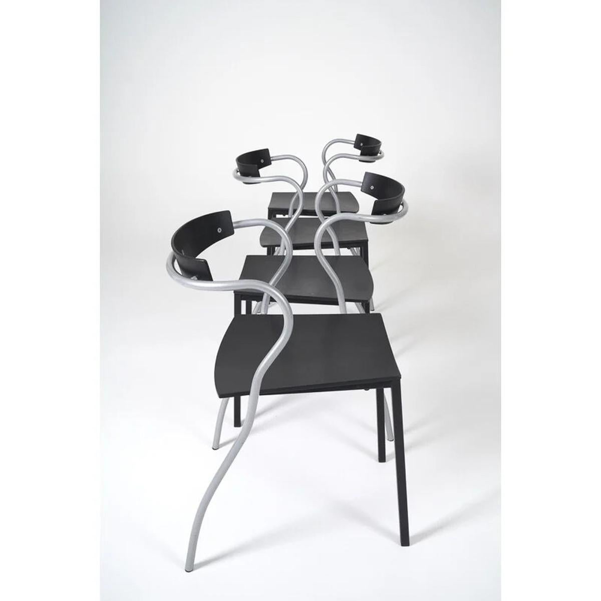 A pair of stackable chairs designed by Pascal Mourgue and manufactured by Artelano in Paris in the early 1990s. Simple and understated yet curvy and sexy, the Rio chairs are made of black enameled curved plywood and curvy tubular metal frames. The