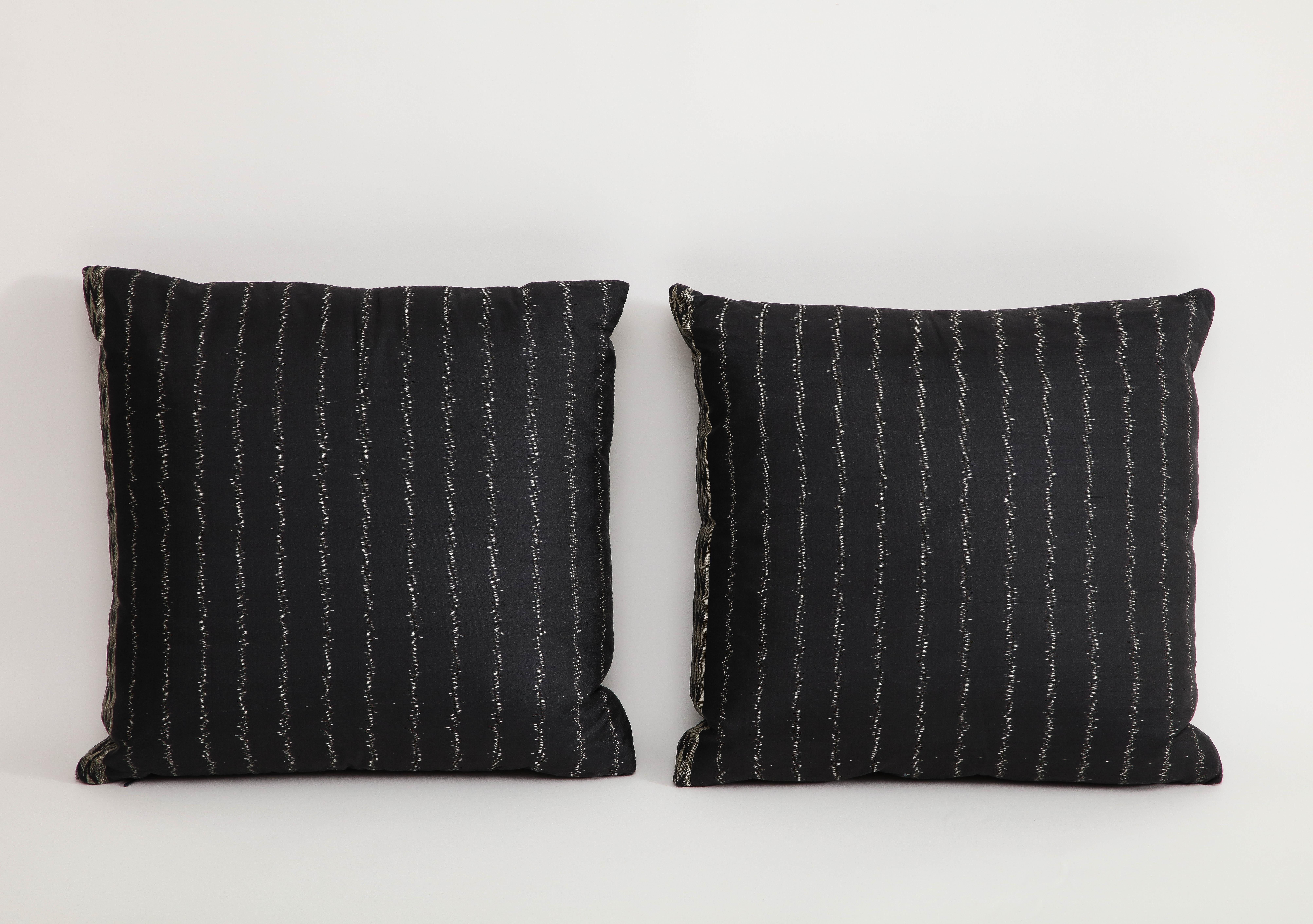 Pair of black pinstriped silk occasional pillows. Sides have complementary pattern. 