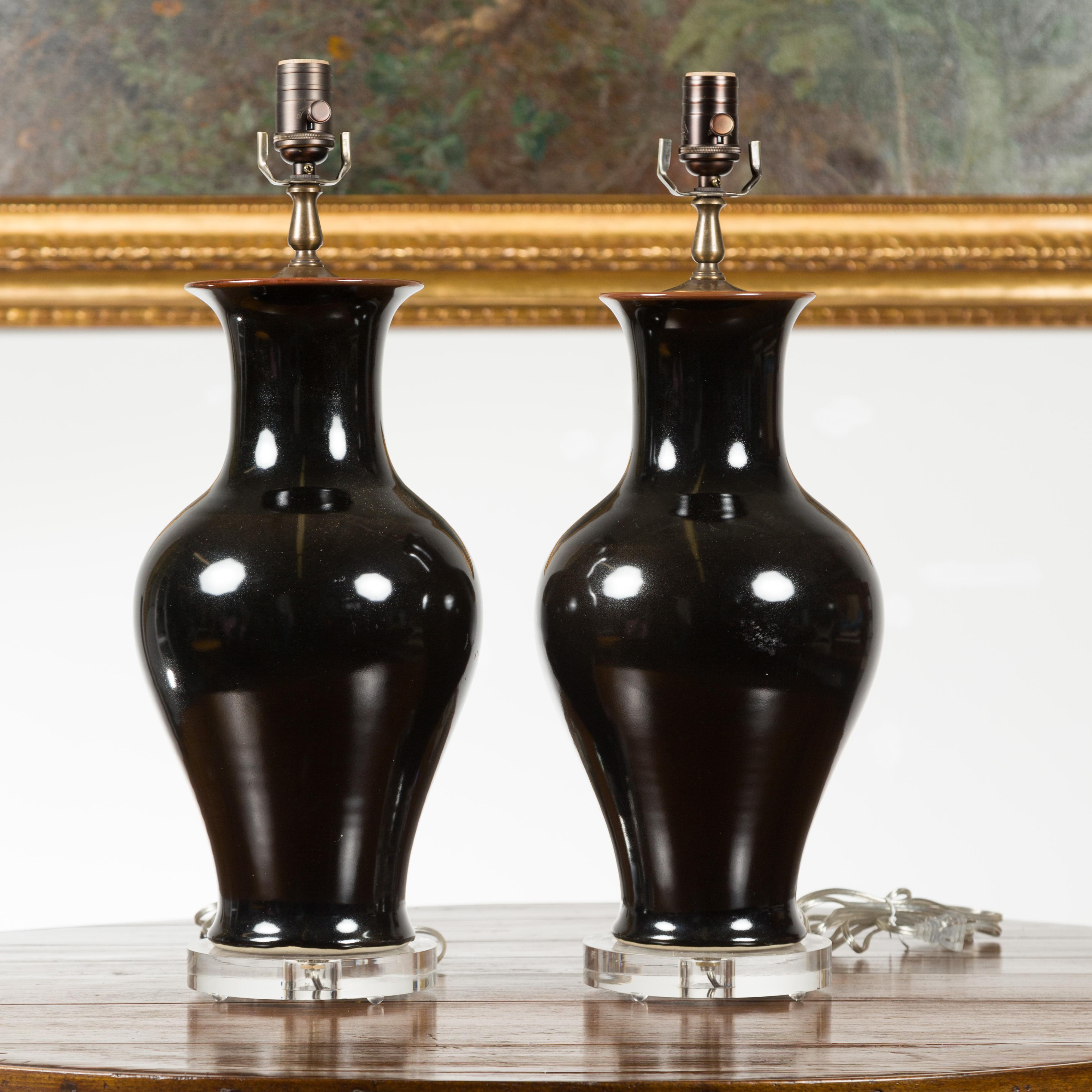 Pair of Black Porcelain Vase Shaped Table Lamps with Round Lucite Bases, Wired In Good Condition For Sale In Atlanta, GA