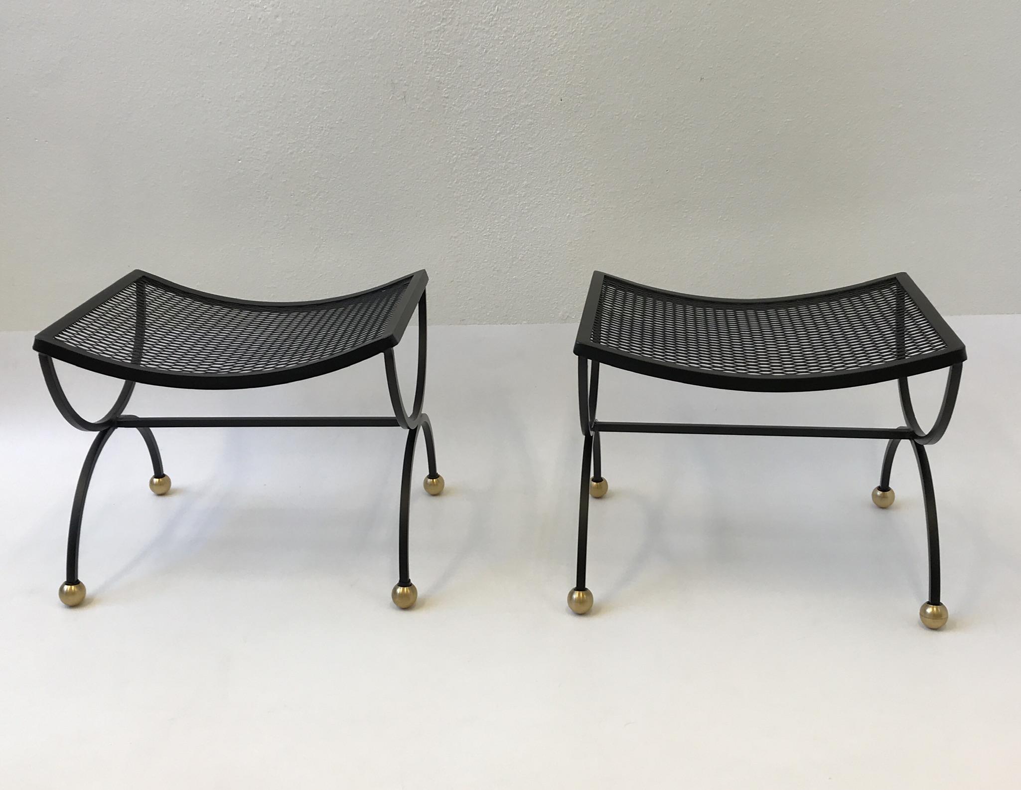A beautiful pair of black powder coated steel with satin brass feel ottoman design by Salterini in the 1960’s. Newly powder coated flat black. They can be used indoors or outdoors. 
Dim: 16” high 20” wide 18” deep.