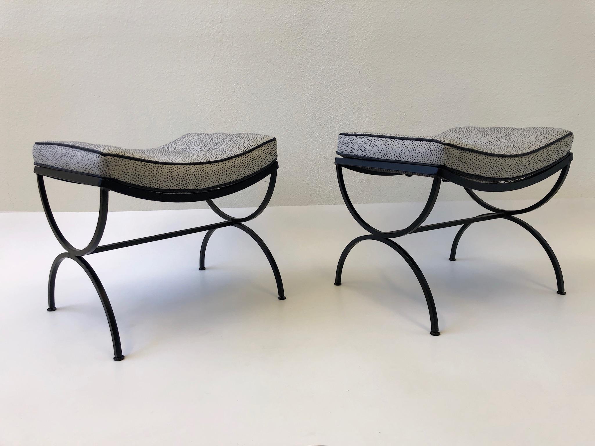 A pair of 1960s black powder coated steel “Sculptura” ottomans by Woodard. The ottoman have been newly powder coated flat black. The new cushions are Sunbrella with black vinyl pippin (see detail photos). 

Dimensions: 20” wide, 17” deep, 18” deep.