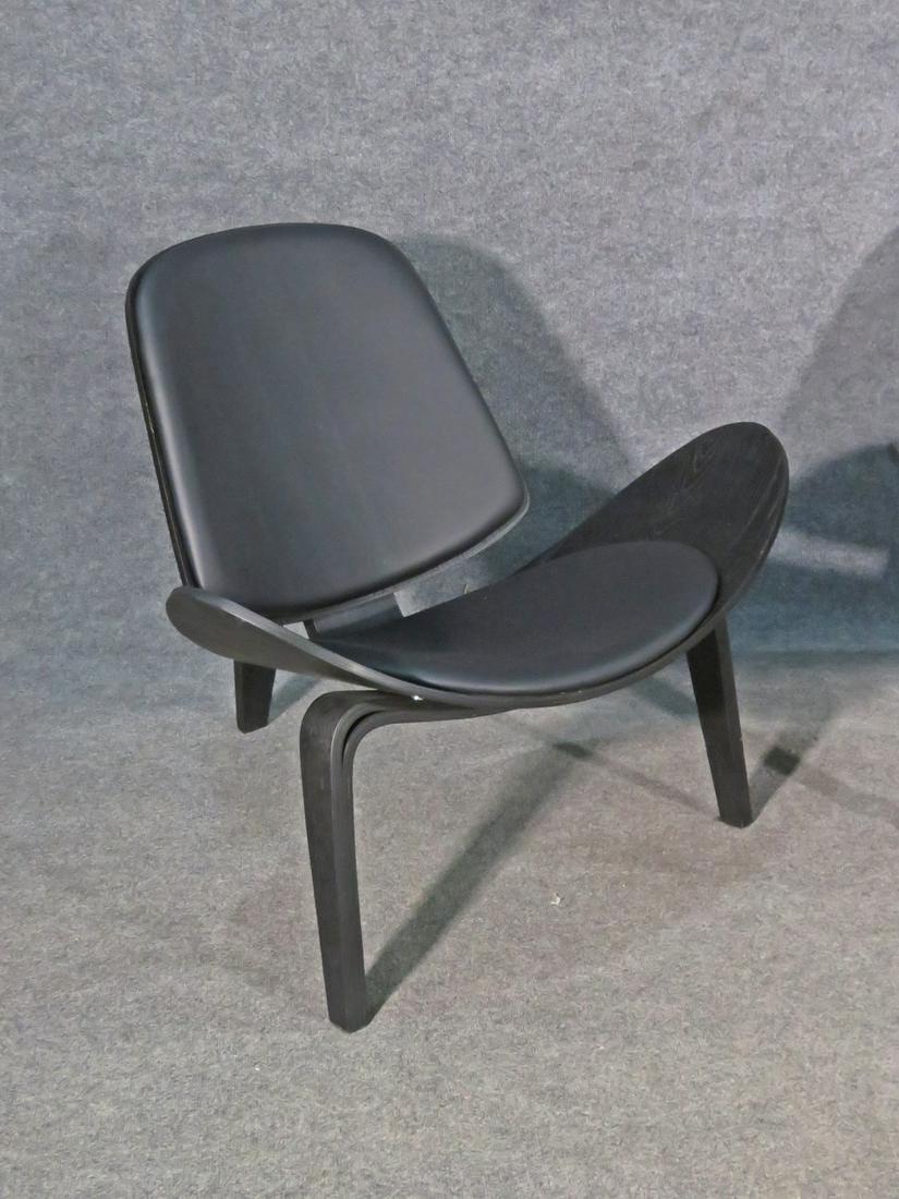 With a unique sleek design, this pair of vintage chairs styled after Hans Wegner is sure to stand out. Please confirm item location with seller (NY/NJ).