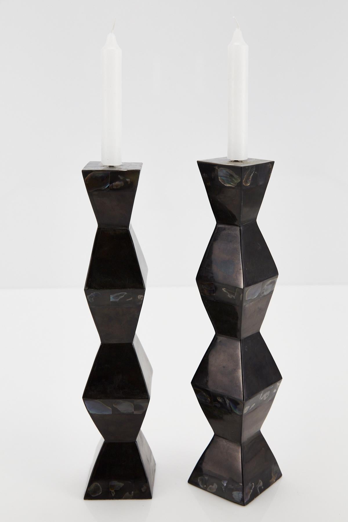 Striking pair of accordion shaped candleholders, completely covered in tessellated black stone and rainbow seashell.

All furnishings are made from 100% natural Fossil Stone or Seashell inlay, carefully hand cut and crafted piece-by-piece and