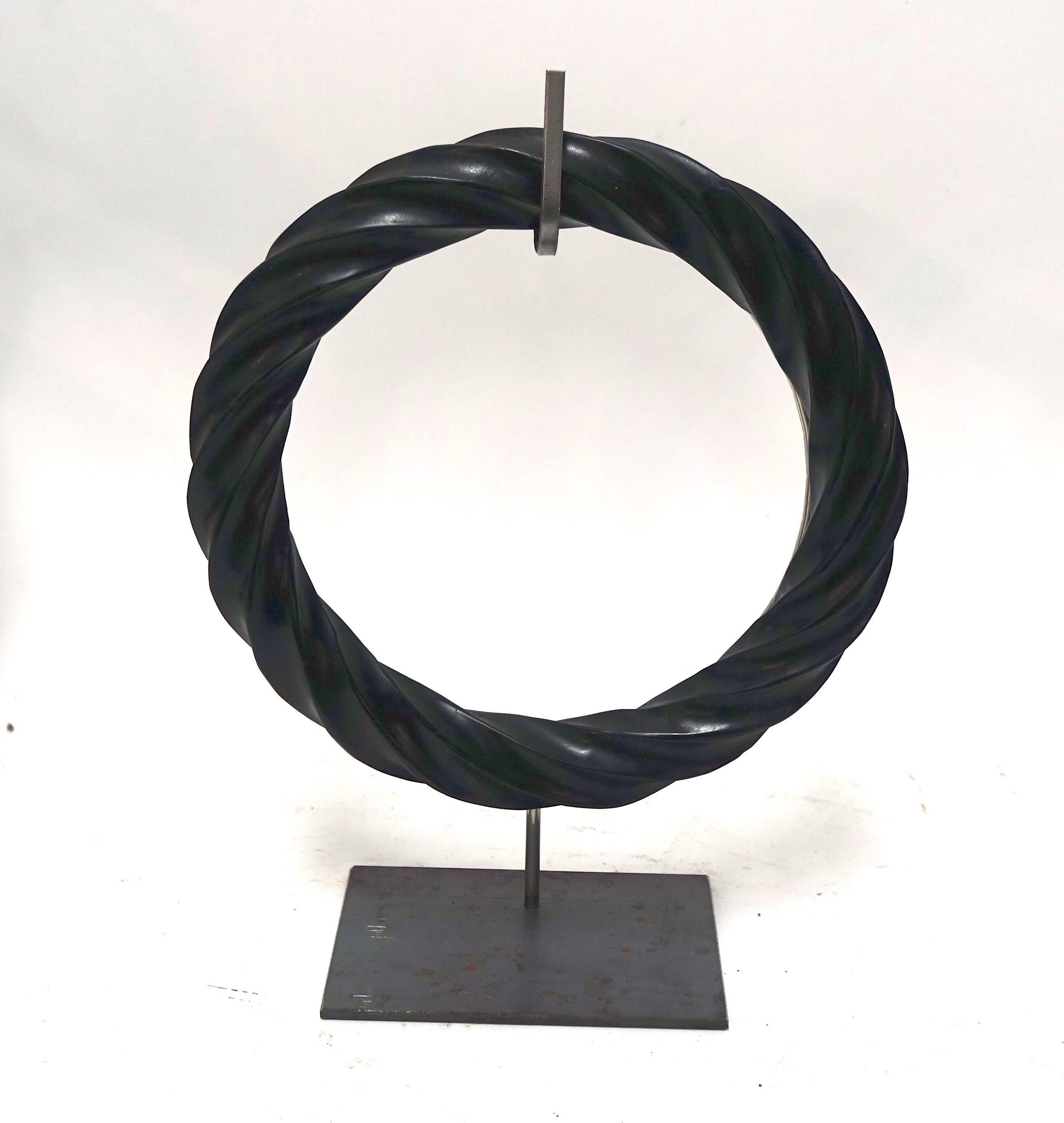 Contemporary Chinese pair of black twisted marble rings on steel stands.
Honed finish.
10