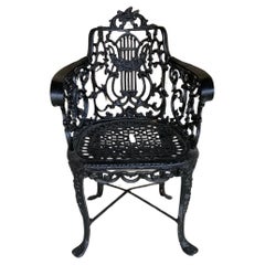 Pair of black Victorian cast iron garden chairs