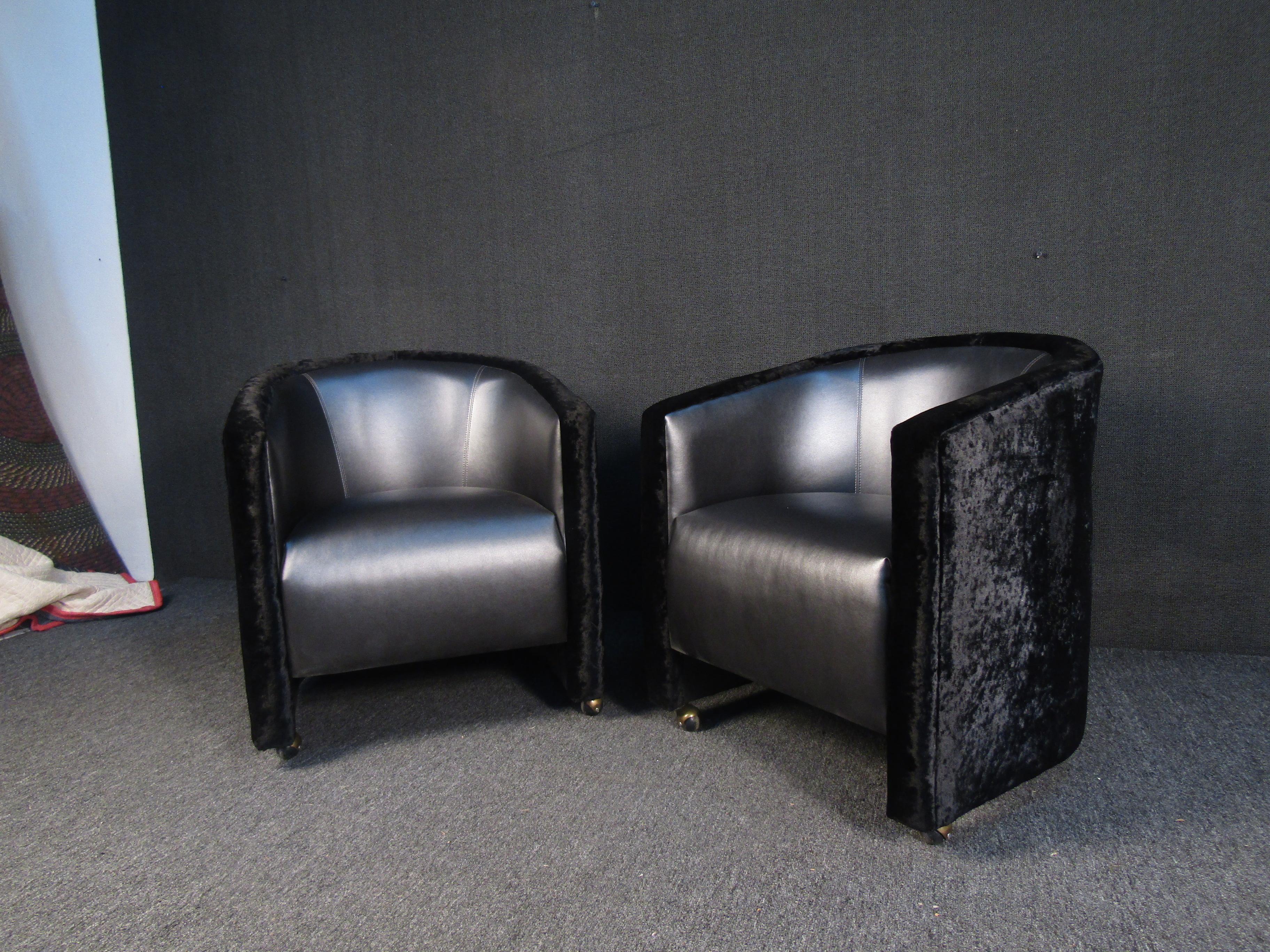 A striking pair of rolling club chairs with contrasting vinyl and velvet upholstery, perfect for any bar room or club. Made by Carson Hospitality. Please confirm item location with seller (NY/NJ).
