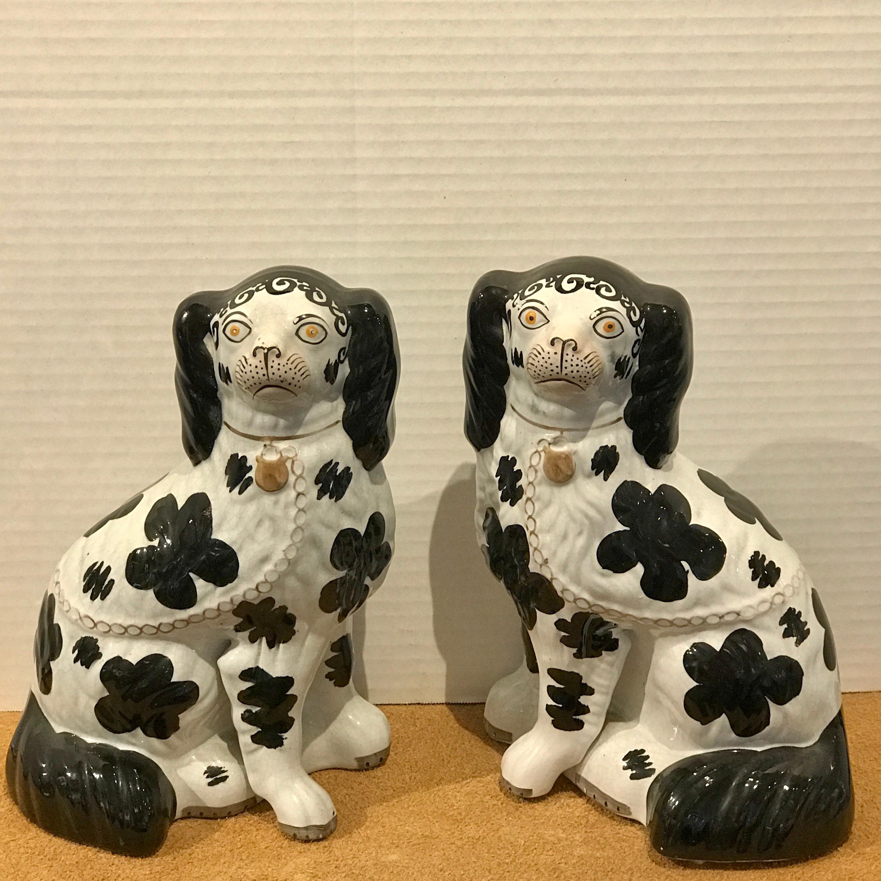 Pair of black and white Staffordshire Disraeli spaniels #H2490
With the desirable feature of separately moulded front legs and with curled tails. Usual decoration of gilt chain and padlock to the necks and body. Disraeli dogs, with curls on their