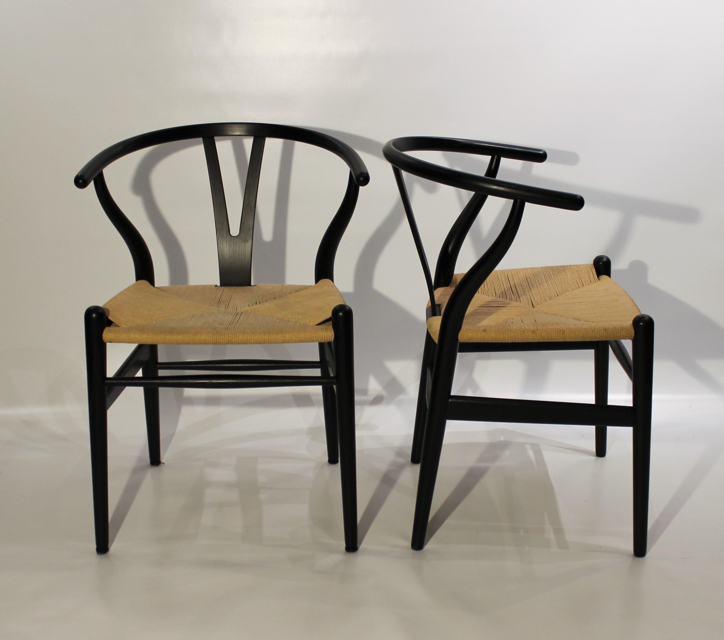 A pair of wishbone chairs, Y-chair, model CH24, designed by Hans J. Wegner in the 1950s and manufactured by Carl Hansen & Son in 2008. The chairs are with papercord seat and black painted ash.