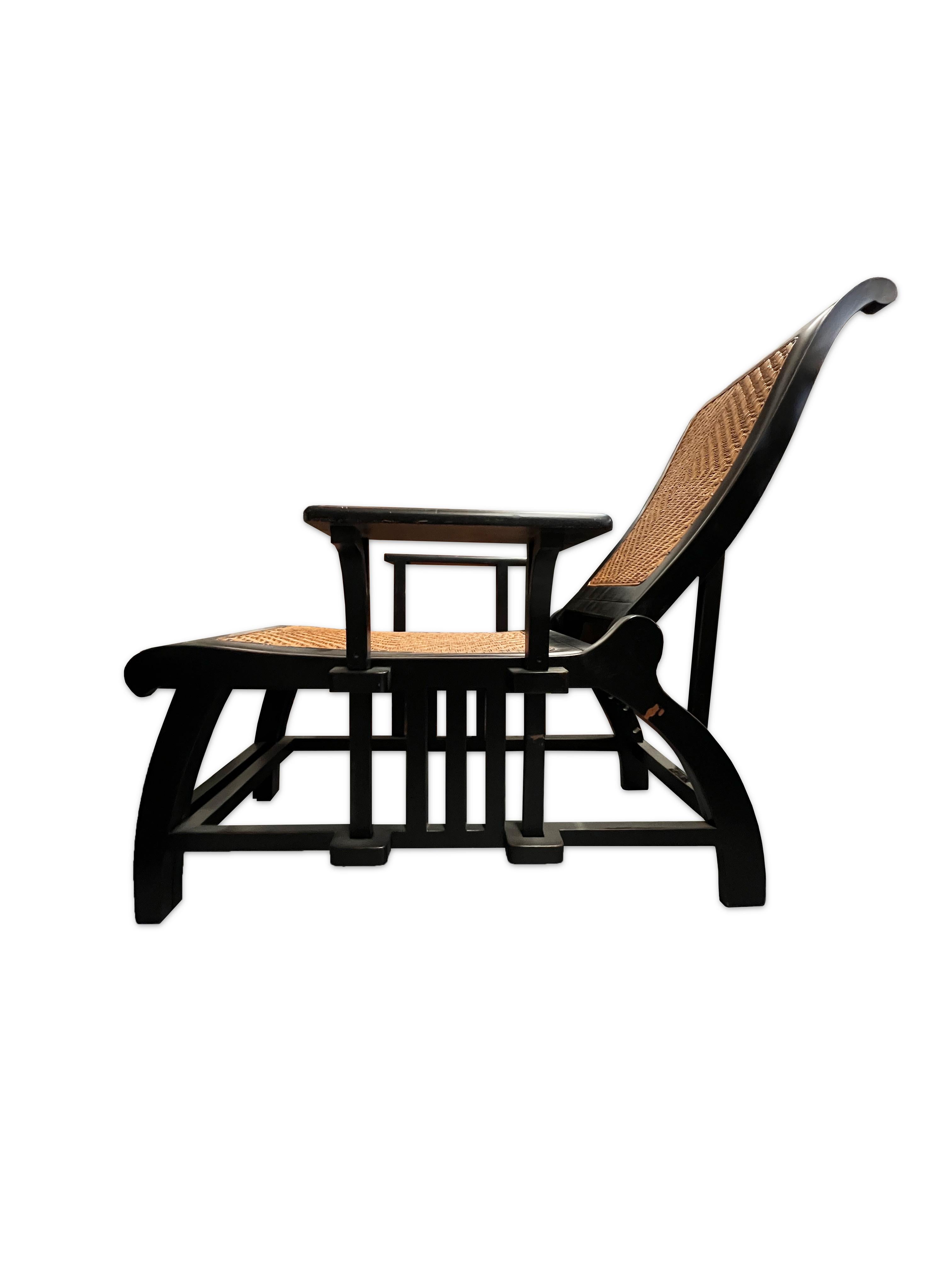 This pair of chaise lounge chairs make for excellent outdoor pieces. This comfortable chair opens to a full chaise lounge and has an adjustable backrest. The backrest and seat are made of woven rattan supported by a black lacquer wooden frame that