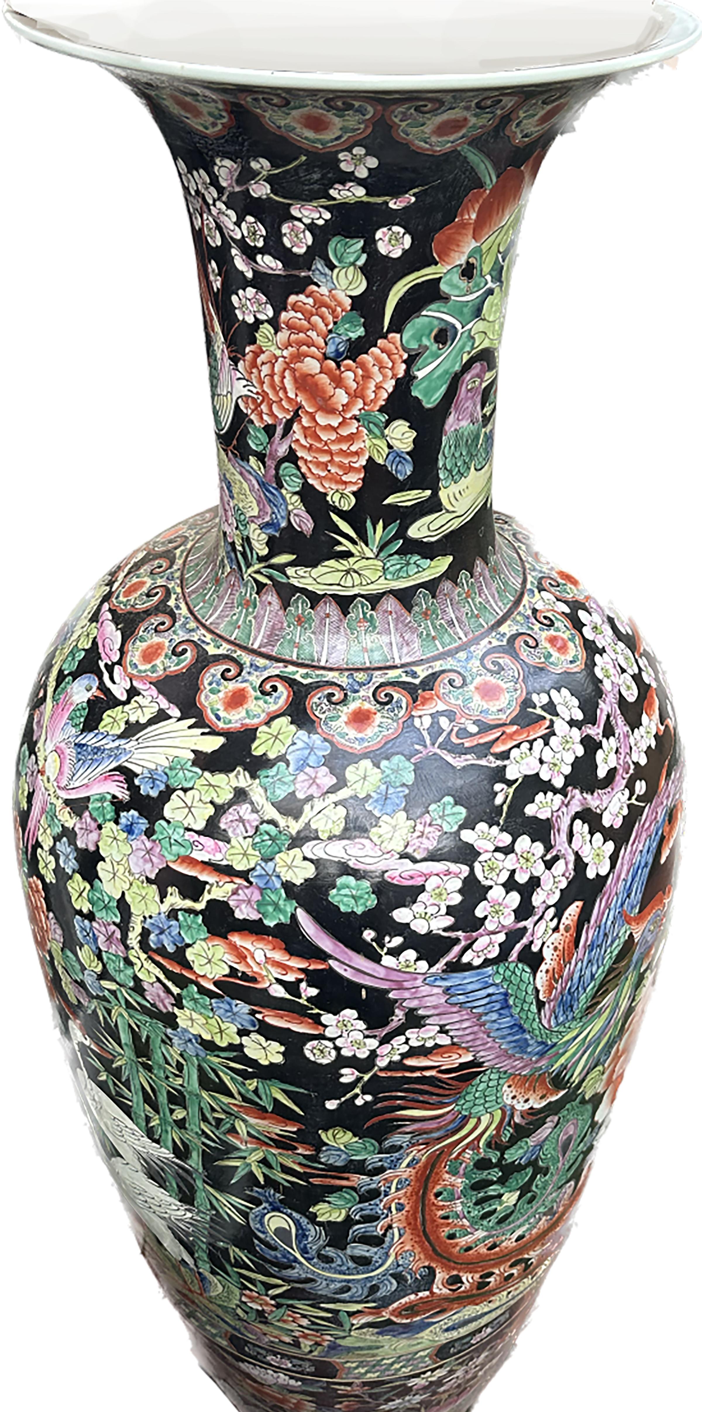 An exquisite pair of monumental hand painted Blackground Chinese porcelain Urns. lead based glaze. 

Bottle shaped body with an open neck is made of the finest porcelain. A collection of spring flora including hydrangeas, white cherry blossoms, and