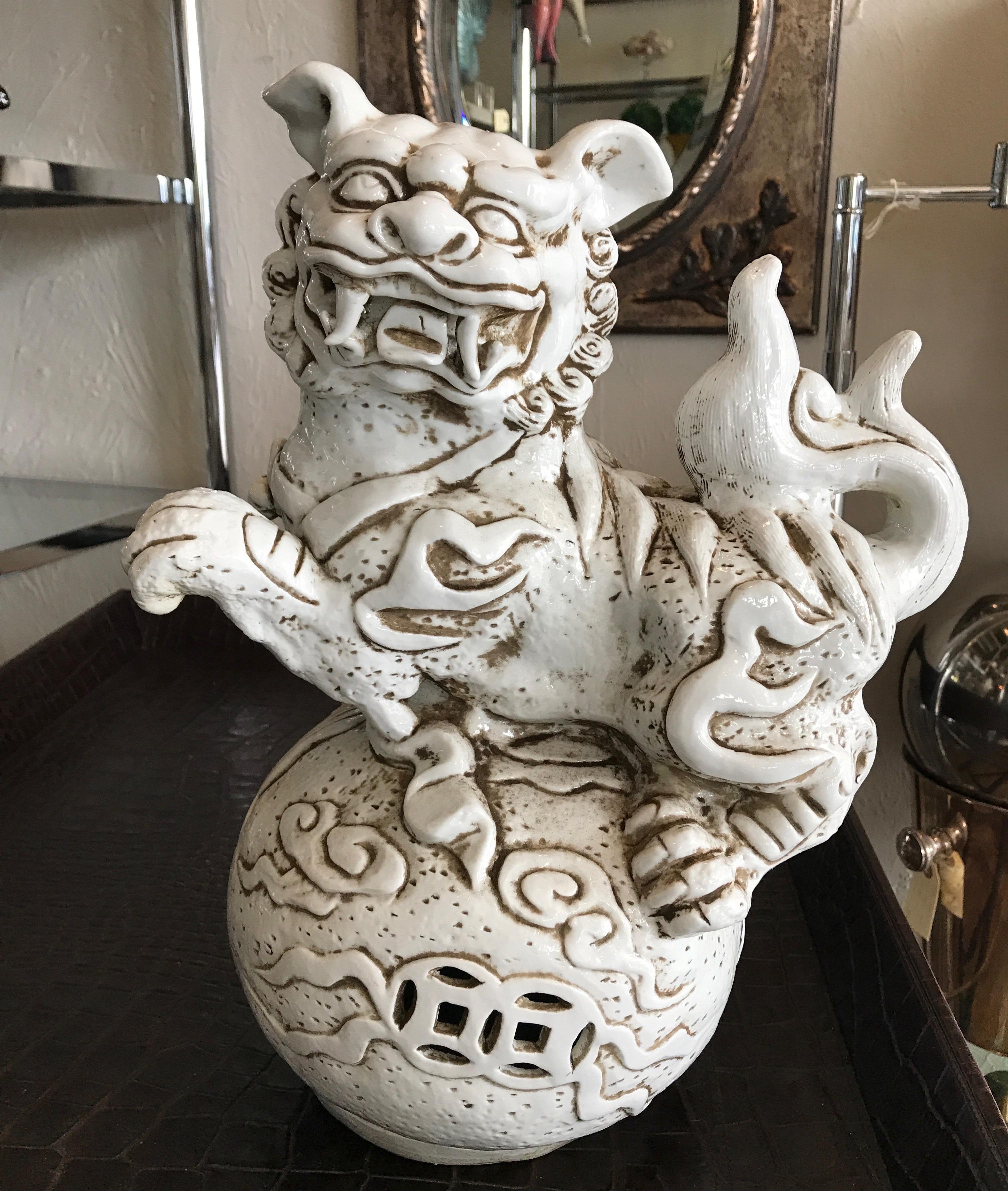 Unusual pair of Chinese Blanc de Chine foo dogs mounted on large orbs.