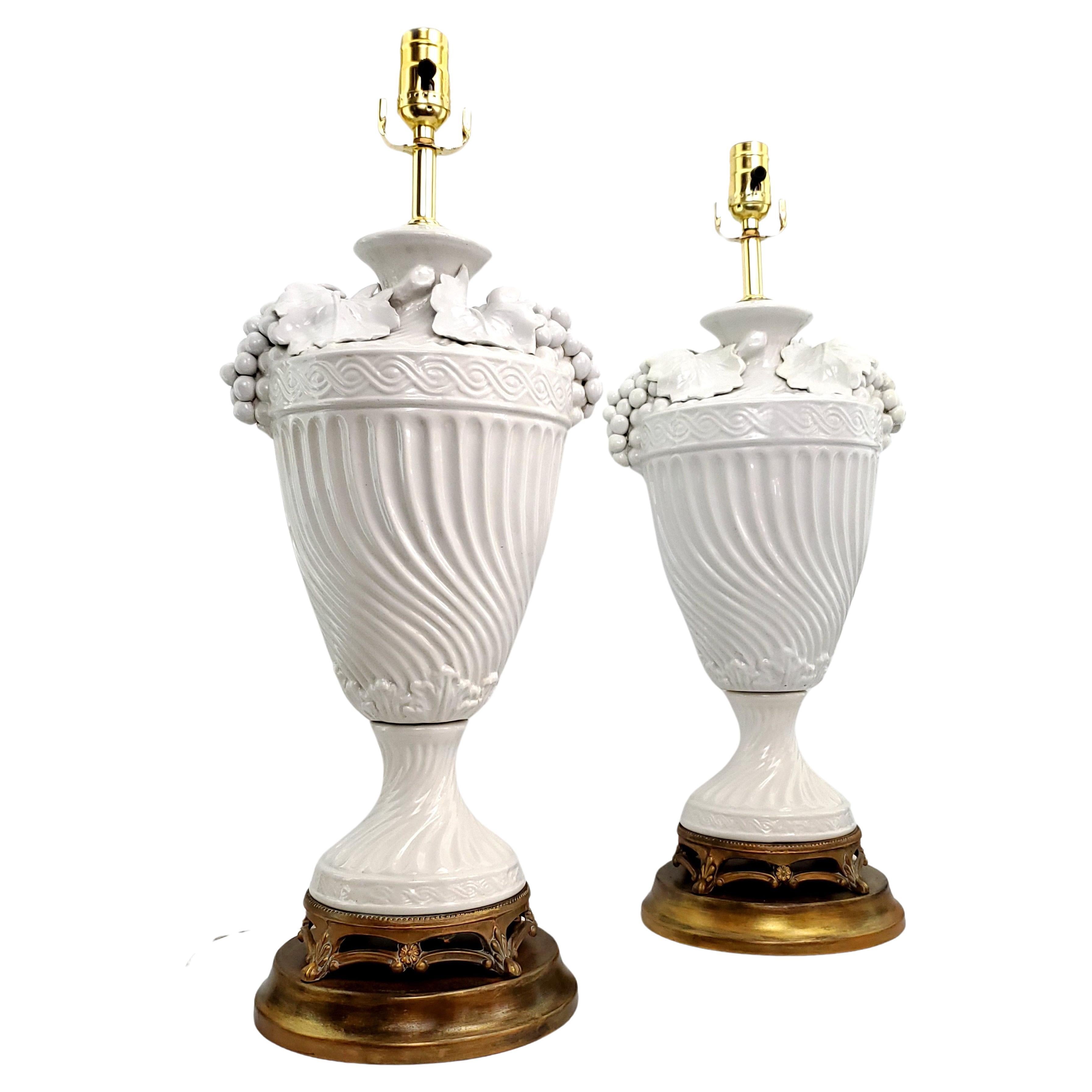 Pair of vintage Italian white Blanc de Chine porcelain table lamps, circa 1950. Both of these large lamps were disassembled, cleaned, and professionally restored.  The metal bases are original to the lamp and were freshened up with a gold metallic
