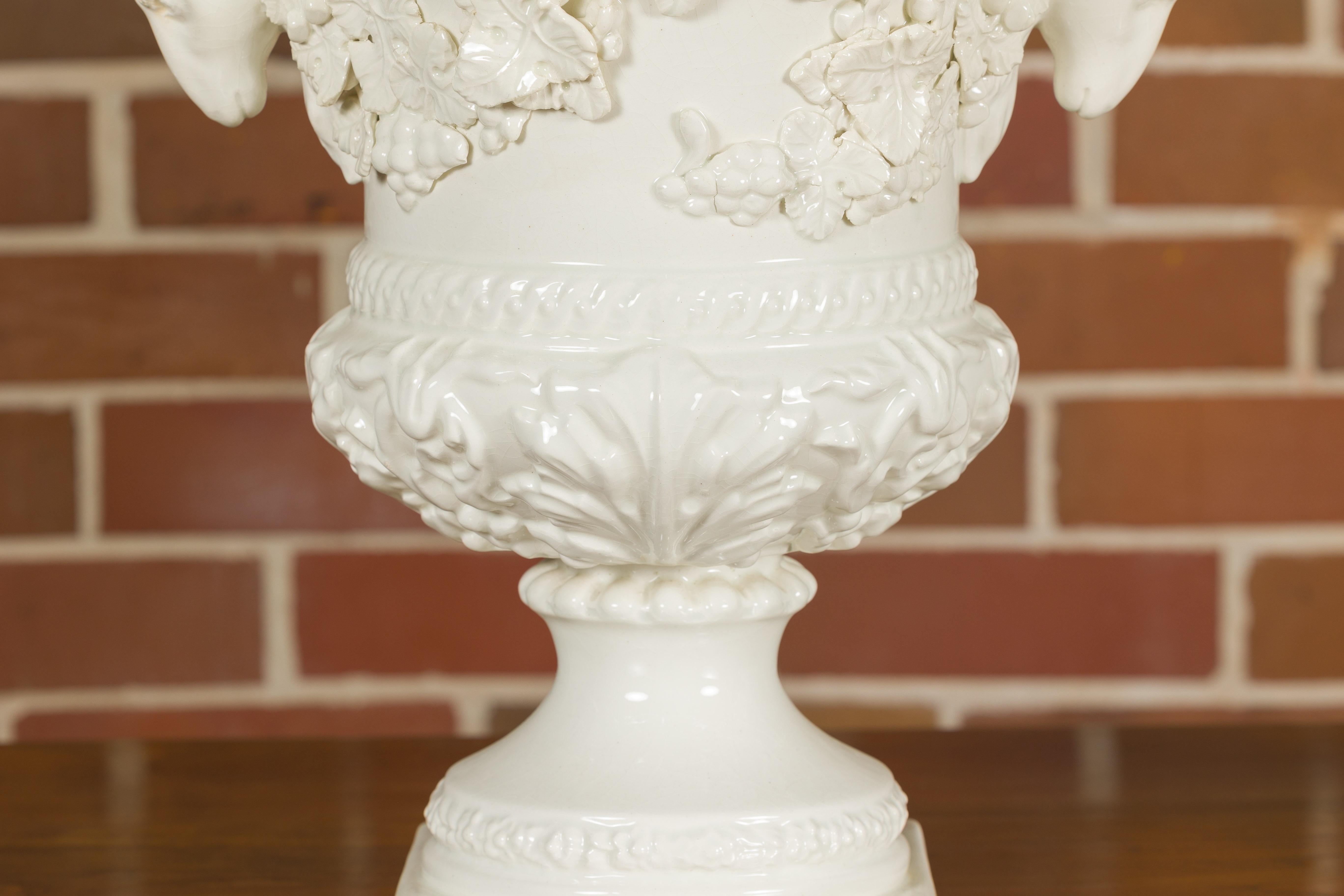 Porcelain Pair of Blanc de Chine Midcentury Urns with Rams Heads and Ivy Leaves For Sale