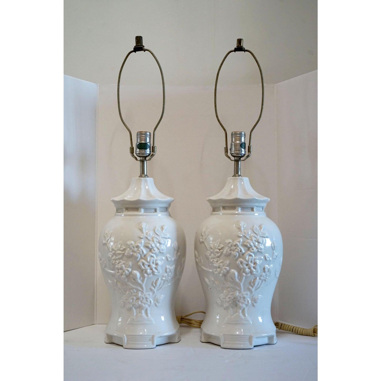 A pair of temple jar blanc de chine lamps are impressive in a variety of settings with their baluster or ginger jar form. They are gorgeous with the most beautiful high glaze imaginable. The porcelain lamps are covered--front and back with engraved