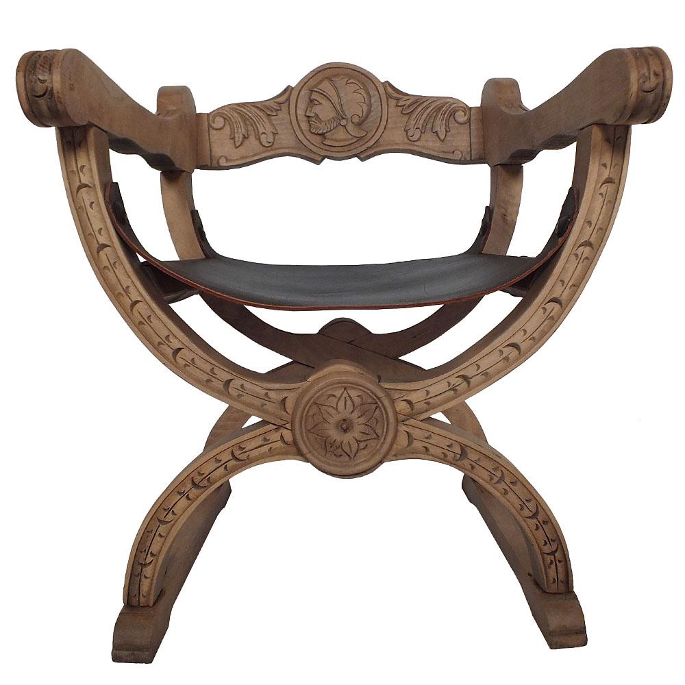 This pair of Early 20th Century Spanish Savonarola-style X-shaped Armchairs feature frames made of bleached wood with intricate hand-carved details throughout. There are carvings of flowers, leaves, and a side profile of a warrior in the center