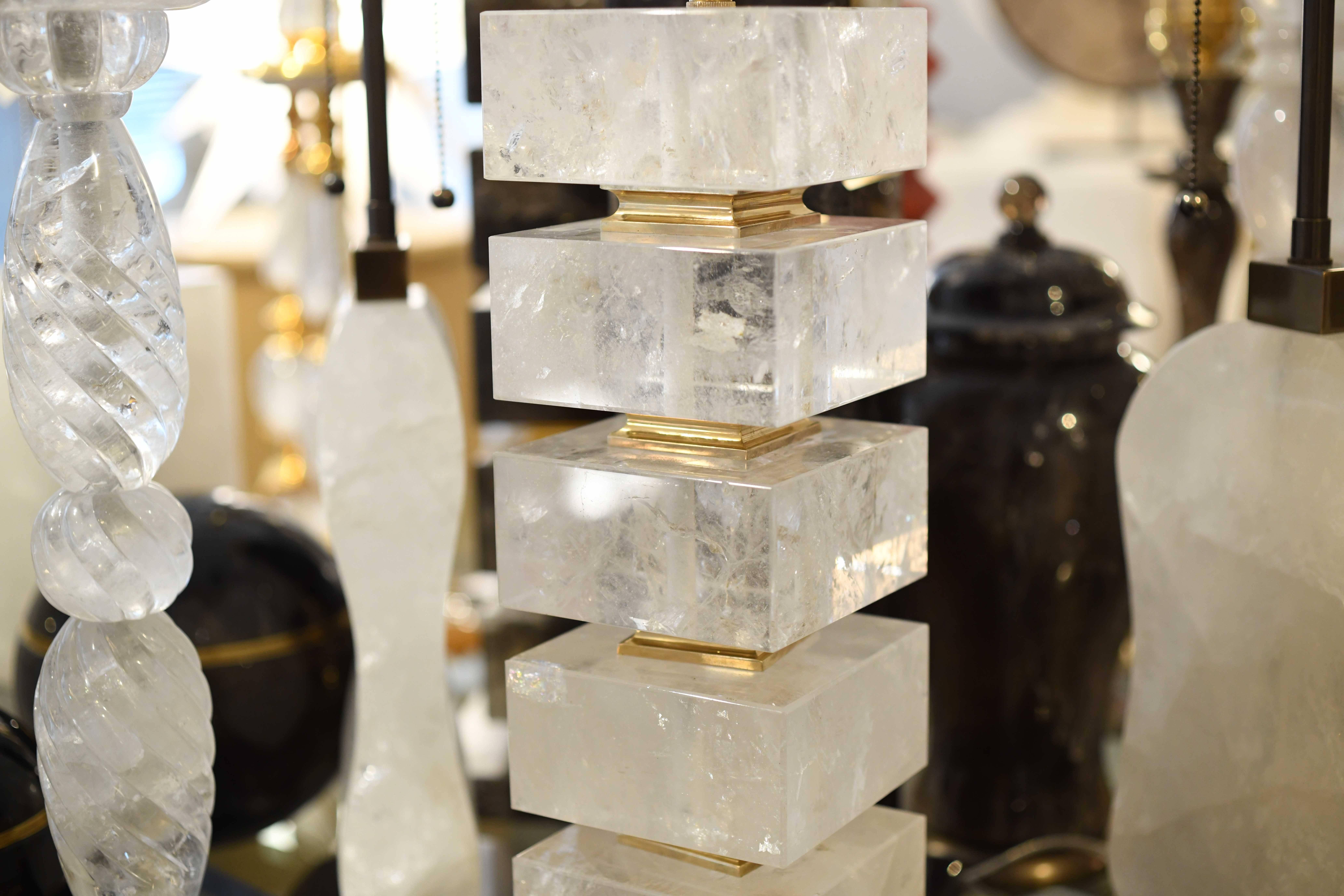 A pair of the block from rock crystal lamps with polished brass bases and inserted decoration. By Phoenix Gallery NYC.
Measure: 18.25 H to the top of the rock crystal.
 