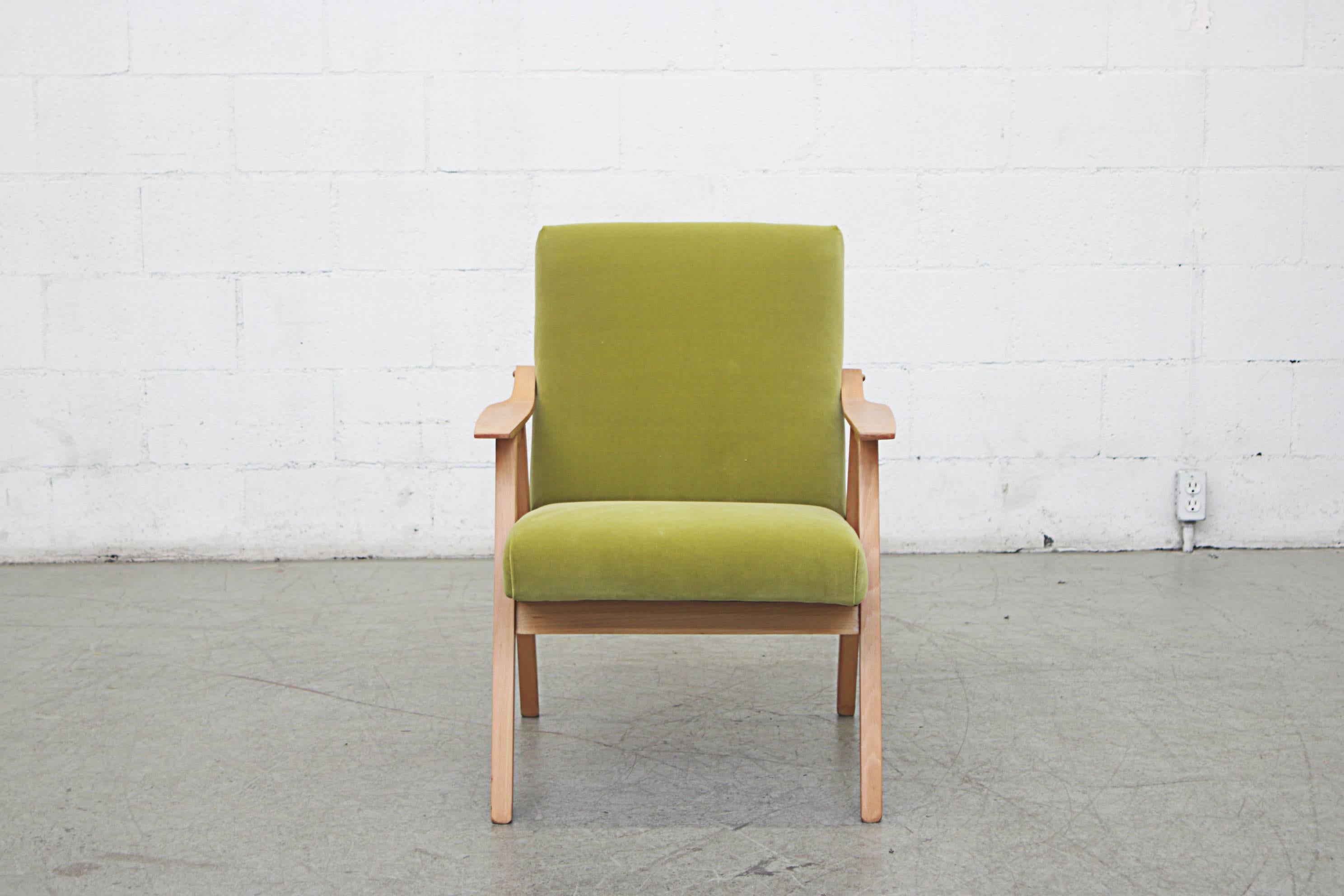 Pair of lightly refinished midcentury lounge chairs with blonde wood frame and arms. Pair of lightly refinished midcentury lounge chairs with blonde wood frame and arms. Newly upholstered in kiwi green velvet. Good original condition, set price.