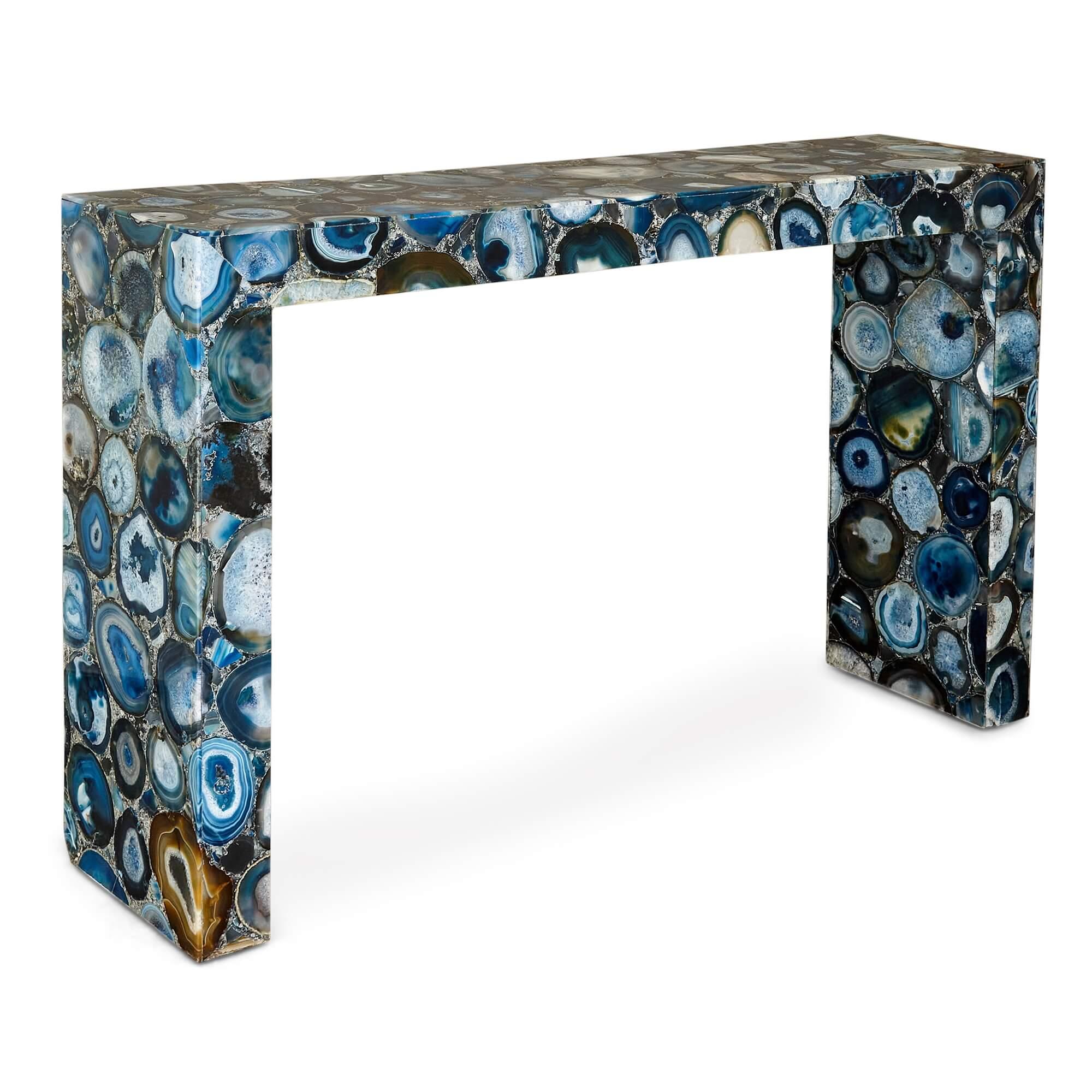 Pair of blue agate console tables 
Continental, 20th Century 
Height 92cm, width 152.5cm, depth 36cm

A blue agate veneer covers the surface of both console tables crafted in the 20th century. The sea of blue circular shapes creates an intriguing