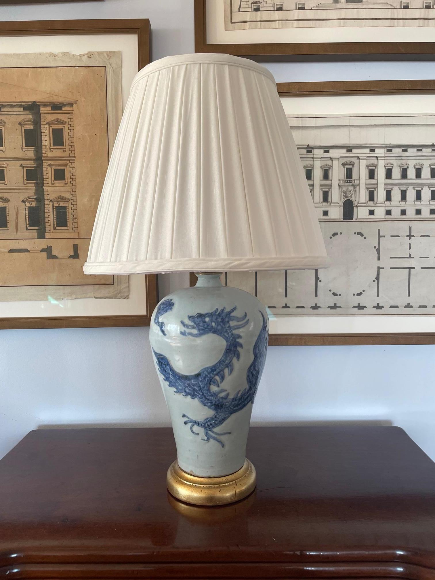 Pair of Blue and White Chinese porcelain lamps with Dragon Motif on gilded bases. 20th Century.