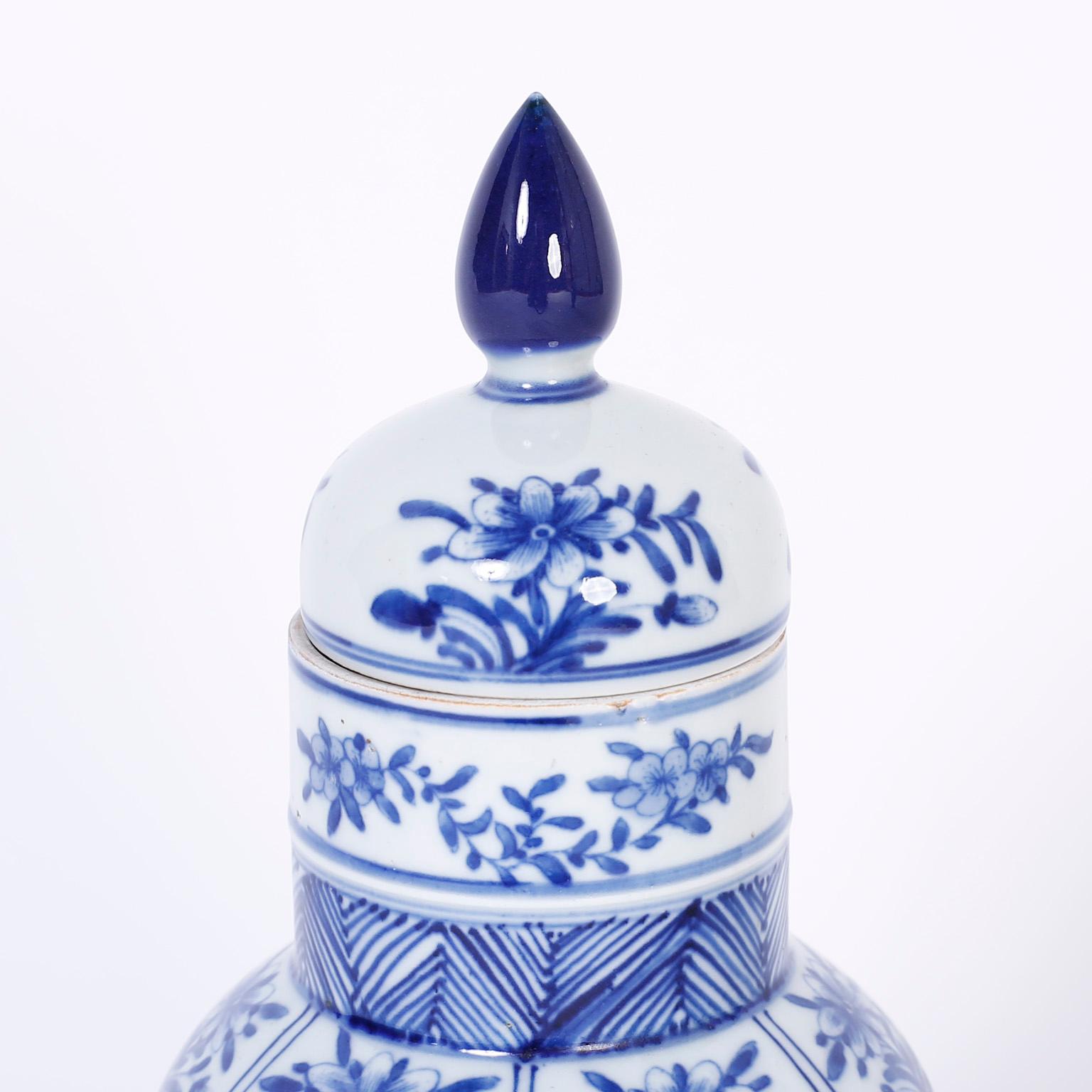 Chinoiserie Pair of Blue and White Chinese Porcelain Lidded Urns