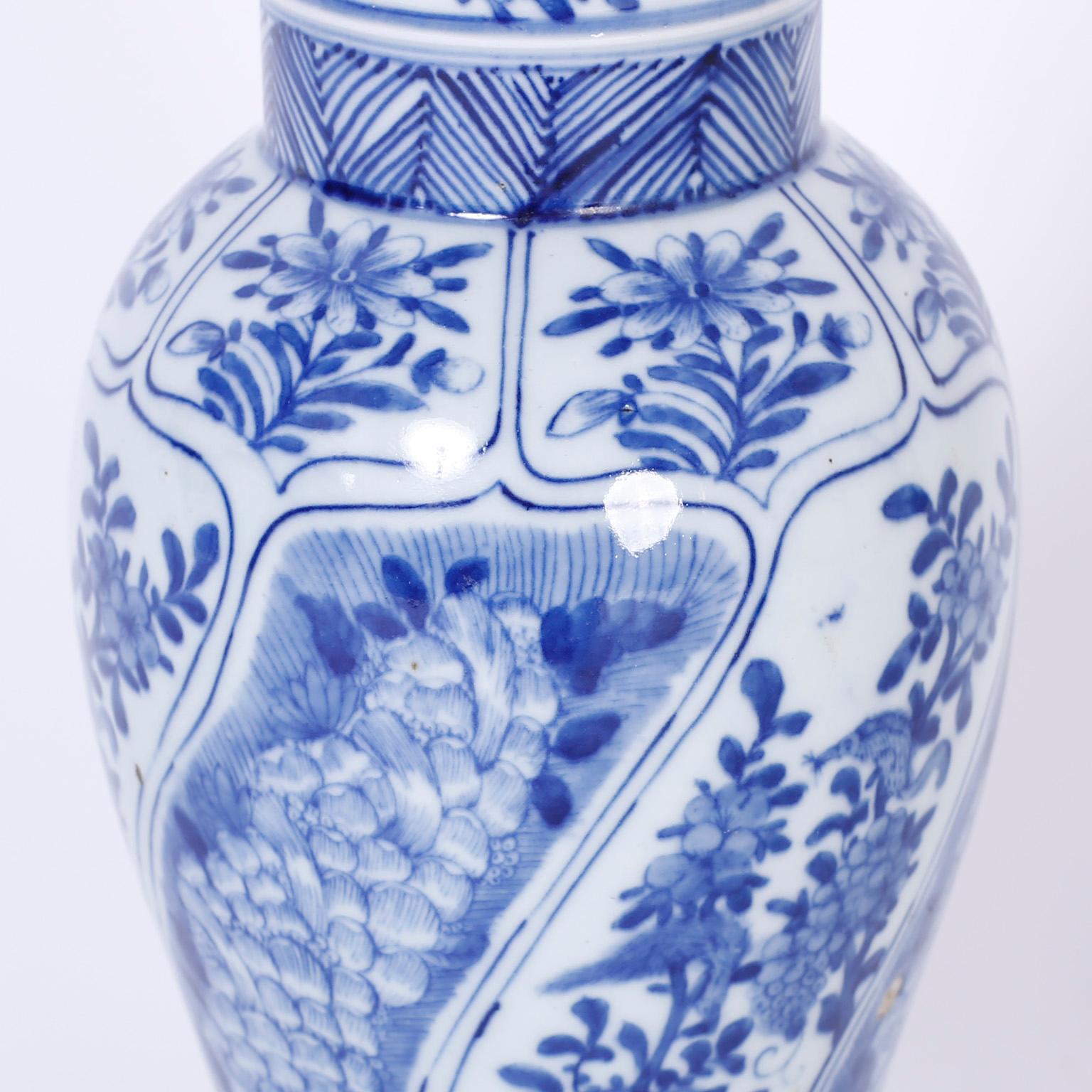 Hand-Painted Pair of Blue and White Chinese Porcelain Lidded Urns