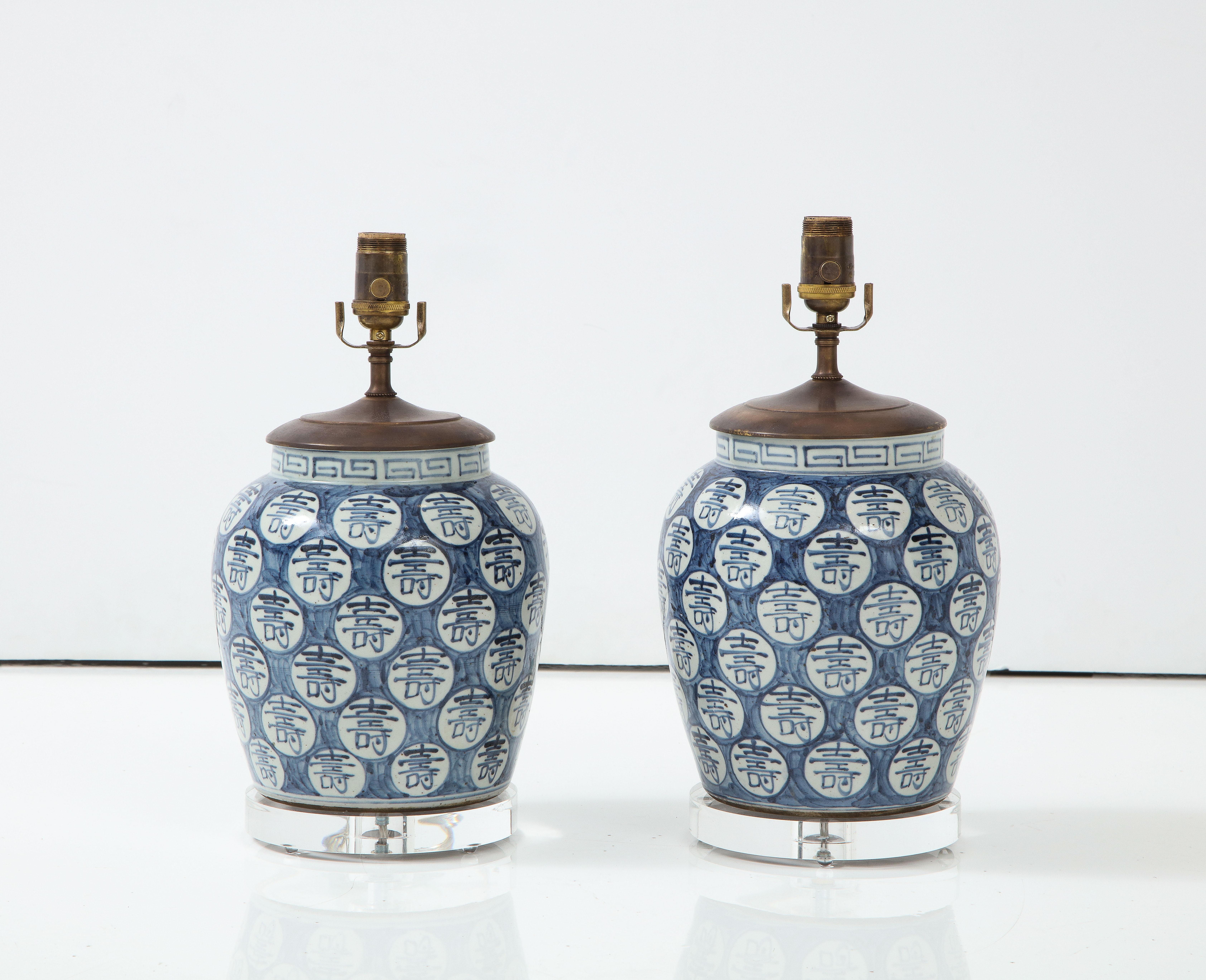 Blue and white will never go out of style. This pair of Chinese export jars have been made into great looking lamps on a lucite base. Their shape is clean and simple, and we consider them almost a neutral--they can work in any color scheme, in